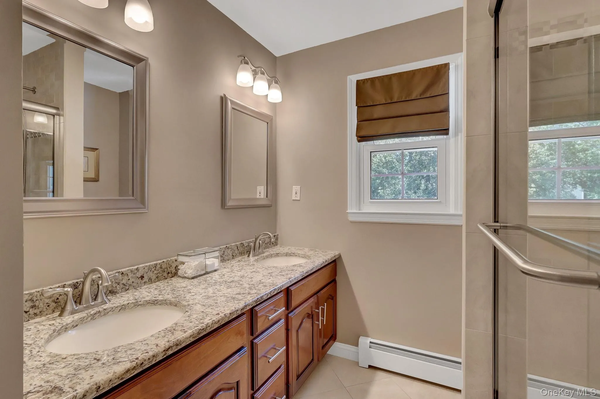 Double vanity featuring granite countertops and undermount sinks Double vanity featuring granite countertops and undermount sinks