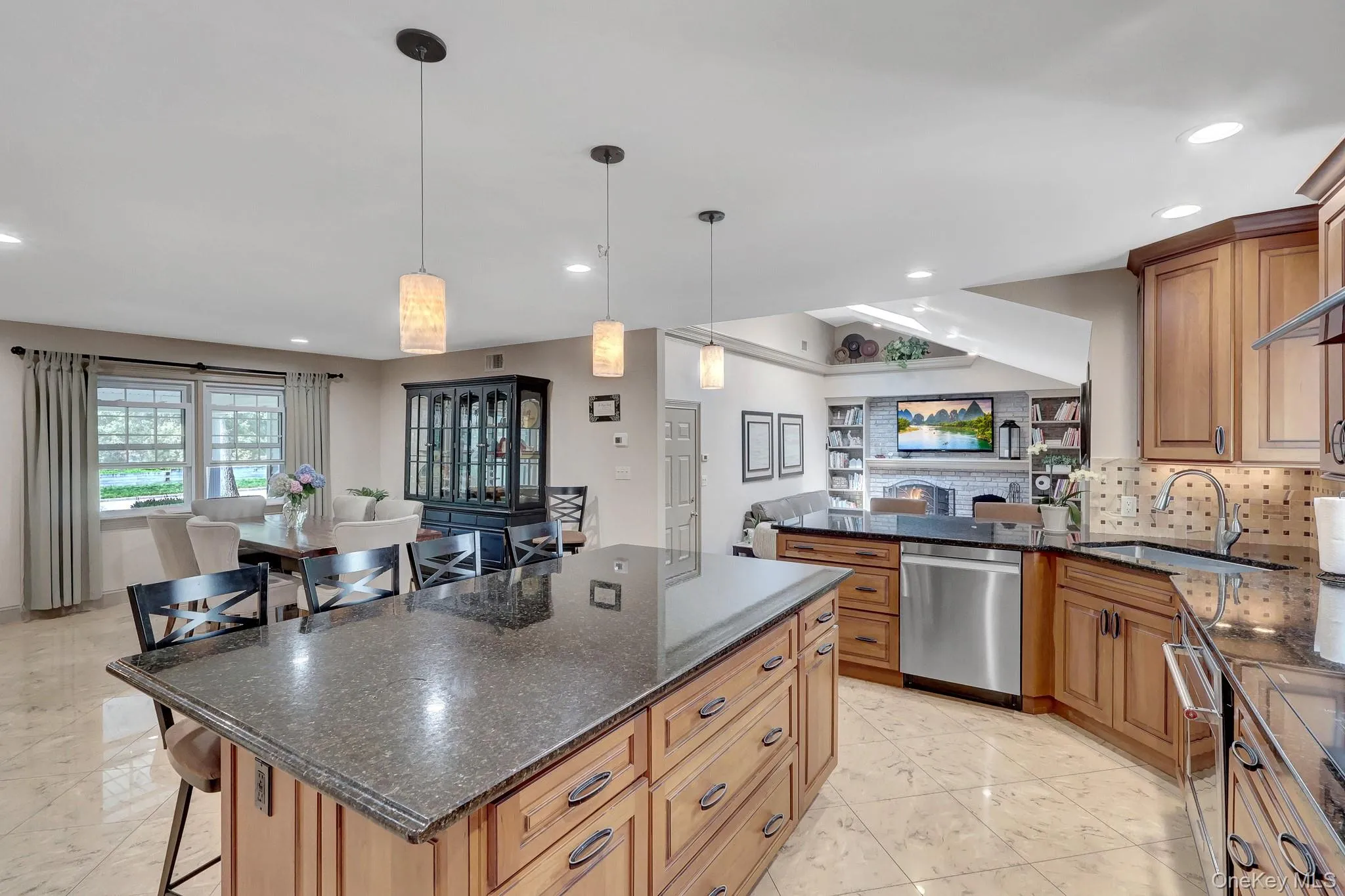 Kitchen island with granite countertop, integrated storage, and pendant lighting Kitchen island with granite countertop, integrated storage, and pendant lighting