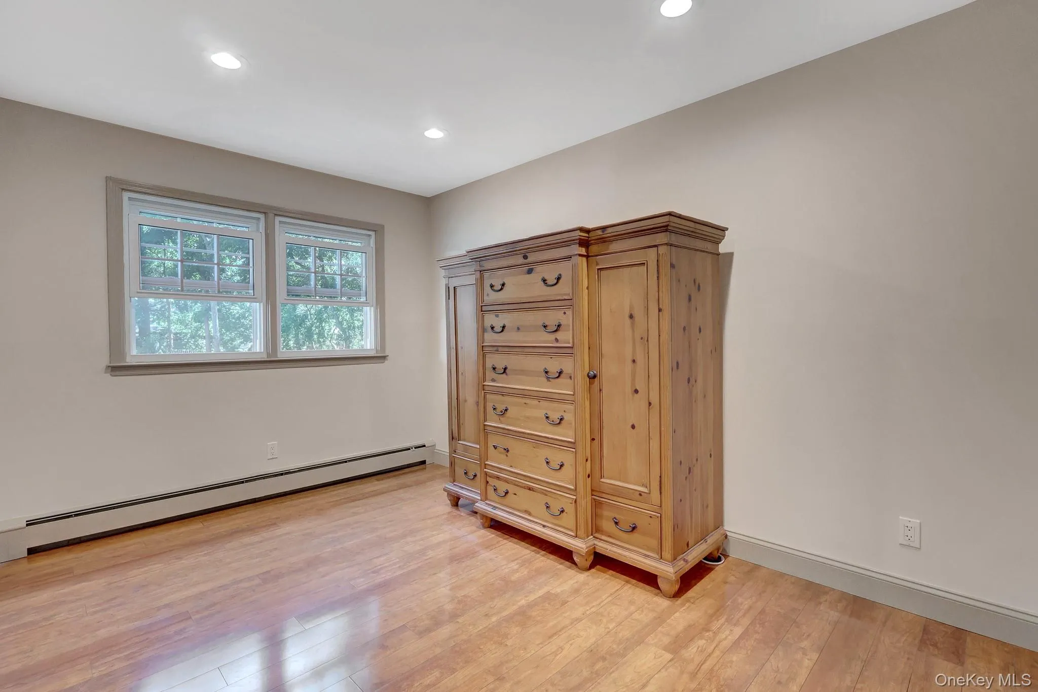 Main level. Wood-finish flooring throughout, recessed lighting, and a large window with exterior views Main level. Wood-finish flooring throughout, recessed lighting, and a large window with exterior views