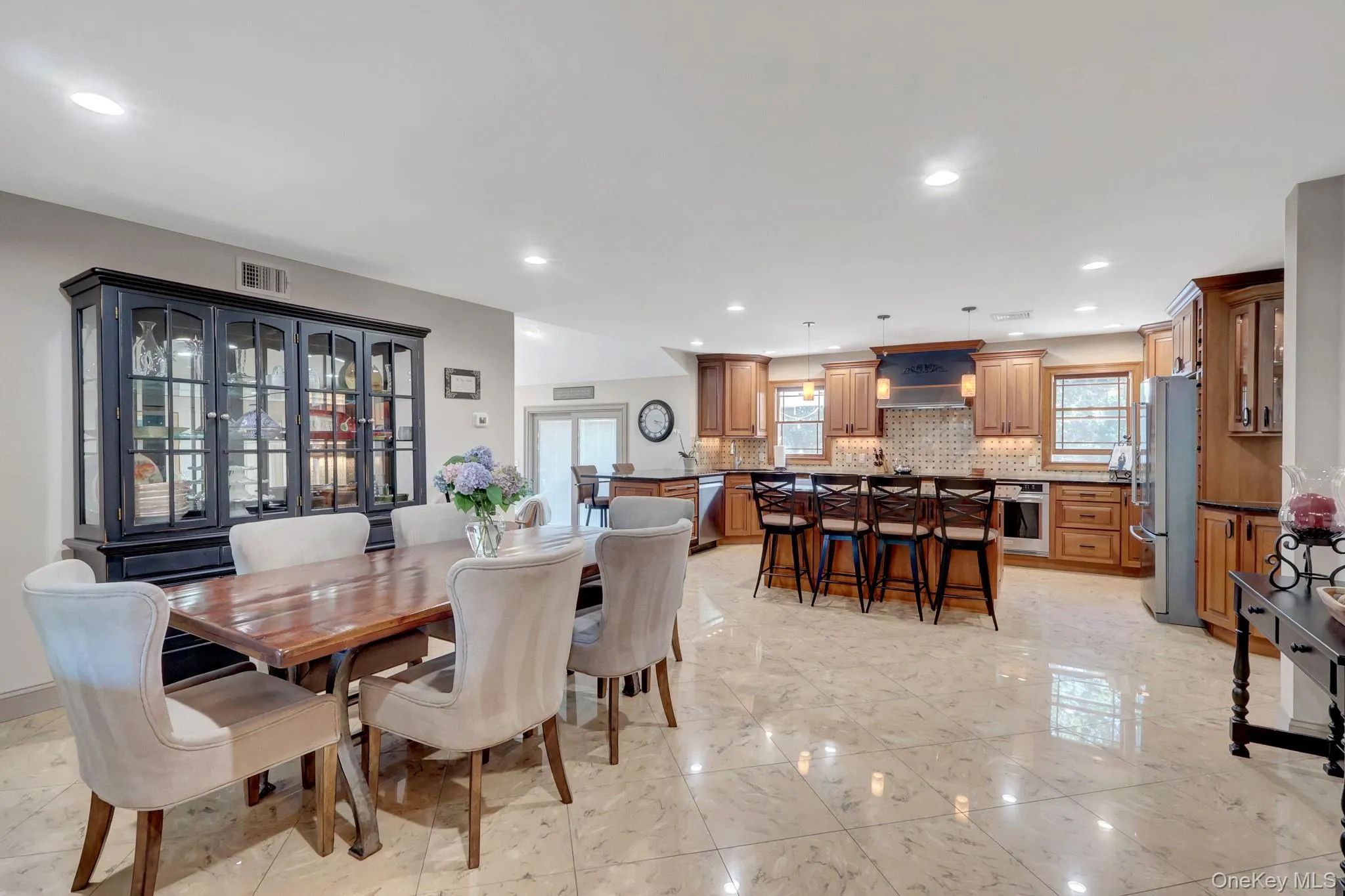 Spacious open-concept living area featuring large format tile flooring throughout Spacious open-concept living area featuring large format tile flooring throughout