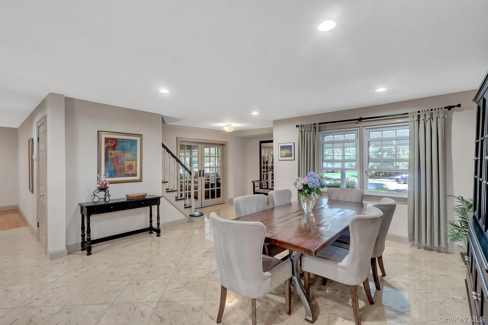 Formal dining area featuring recessed lighting, large windows, and neutral wall tones Formal dining area featuring recessed lighting, large windows, and neutral wall tones