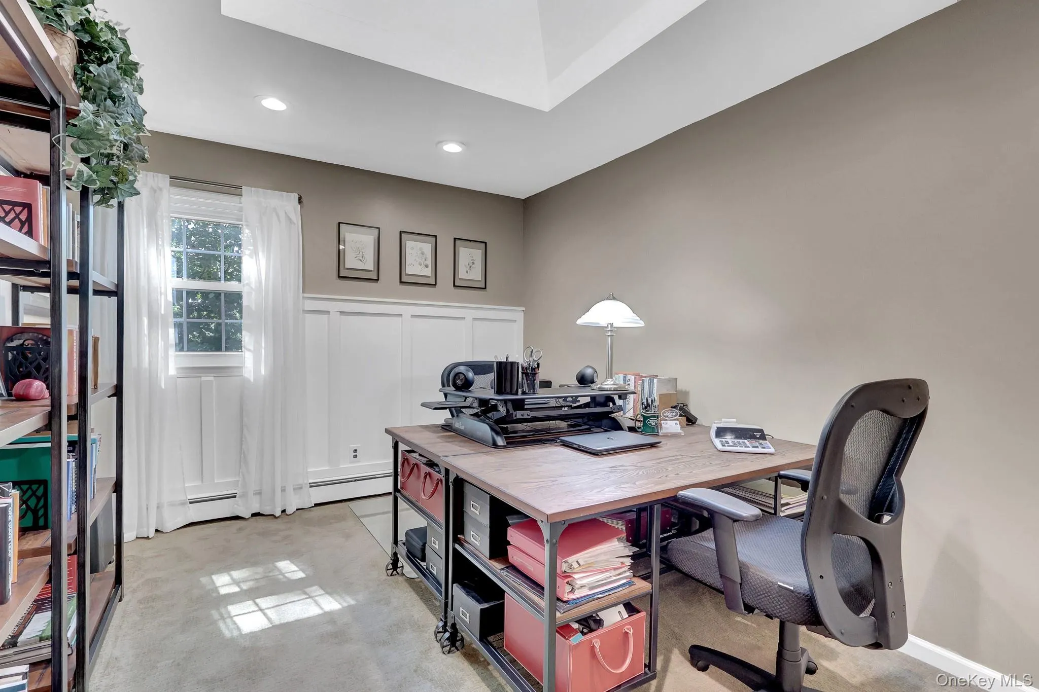 Bedroom used as an office. Recessed lighting illuminates this room, featuring wainscoting, a single window, and neutral-toned walls Bedroom used as an office. Recessed lighting illuminates this room, featuring wainscoting, a single window, and neutral-toned walls
