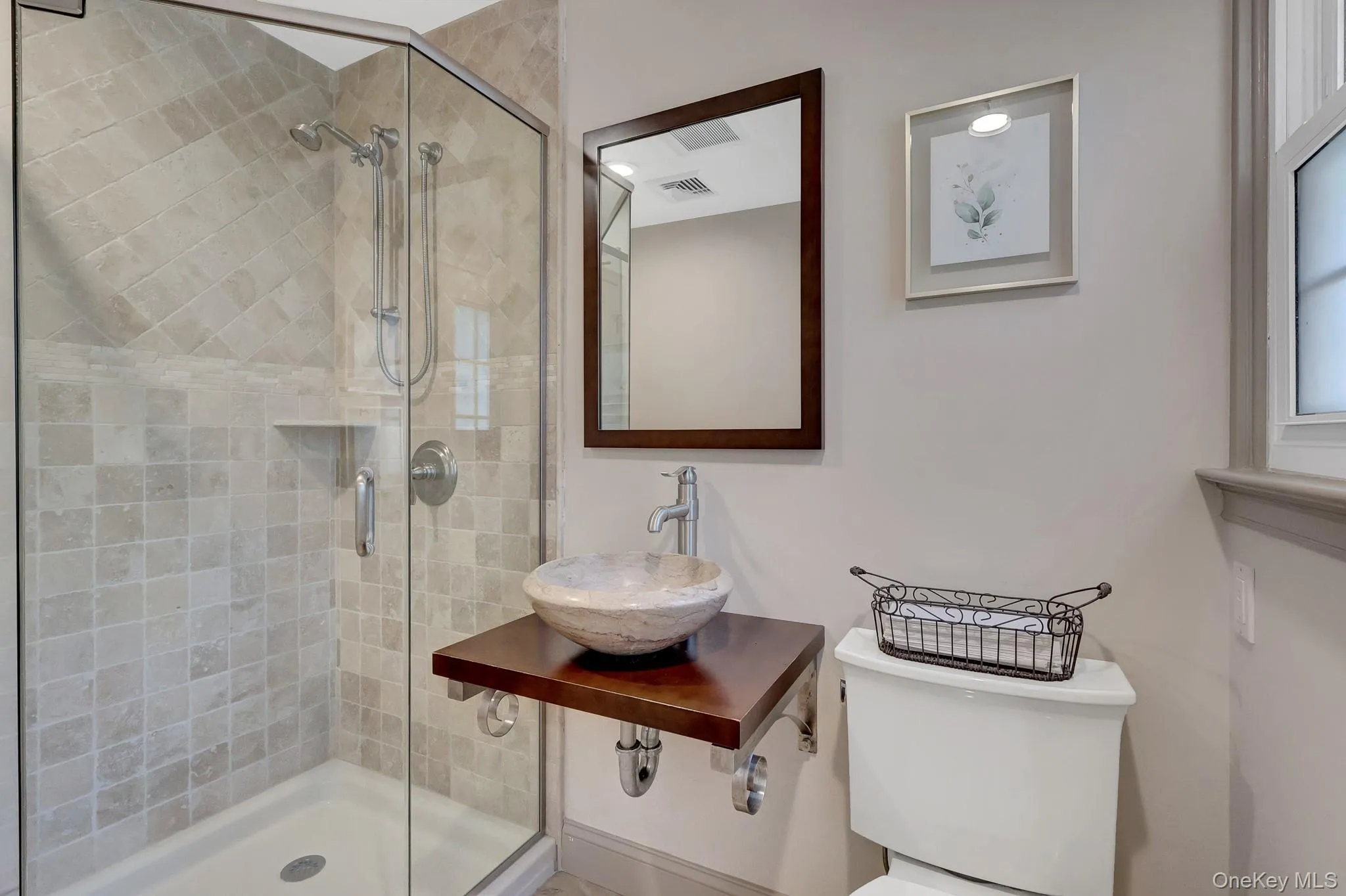 Glass-enclosed shower with tiled walls and built-in shelf Glass-enclosed shower with tiled walls and built-in shelf