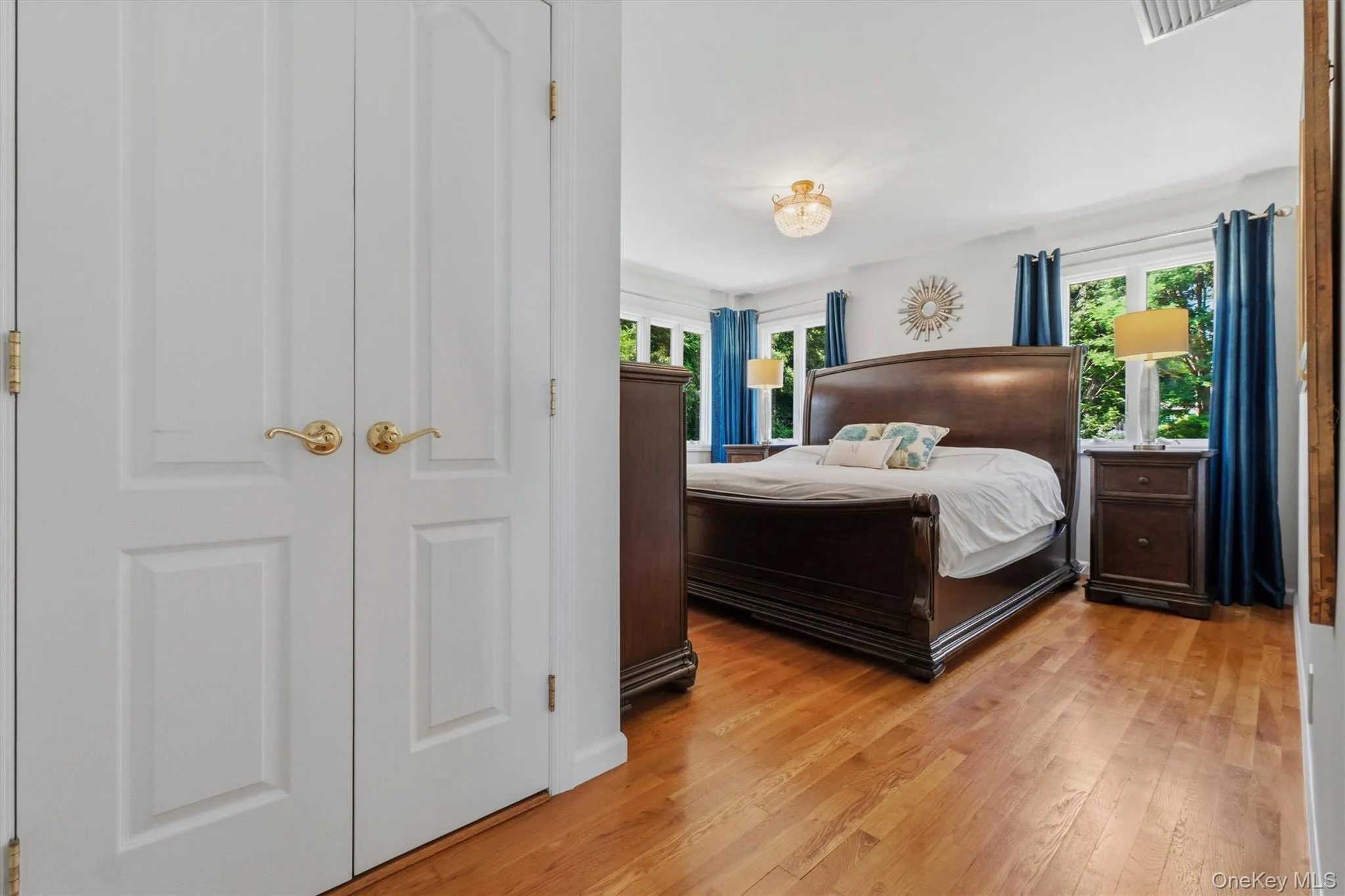 Primary bedroom w/very large closets, views to grounds & pool Primary bedroom w/very large closets, views to grounds & pool