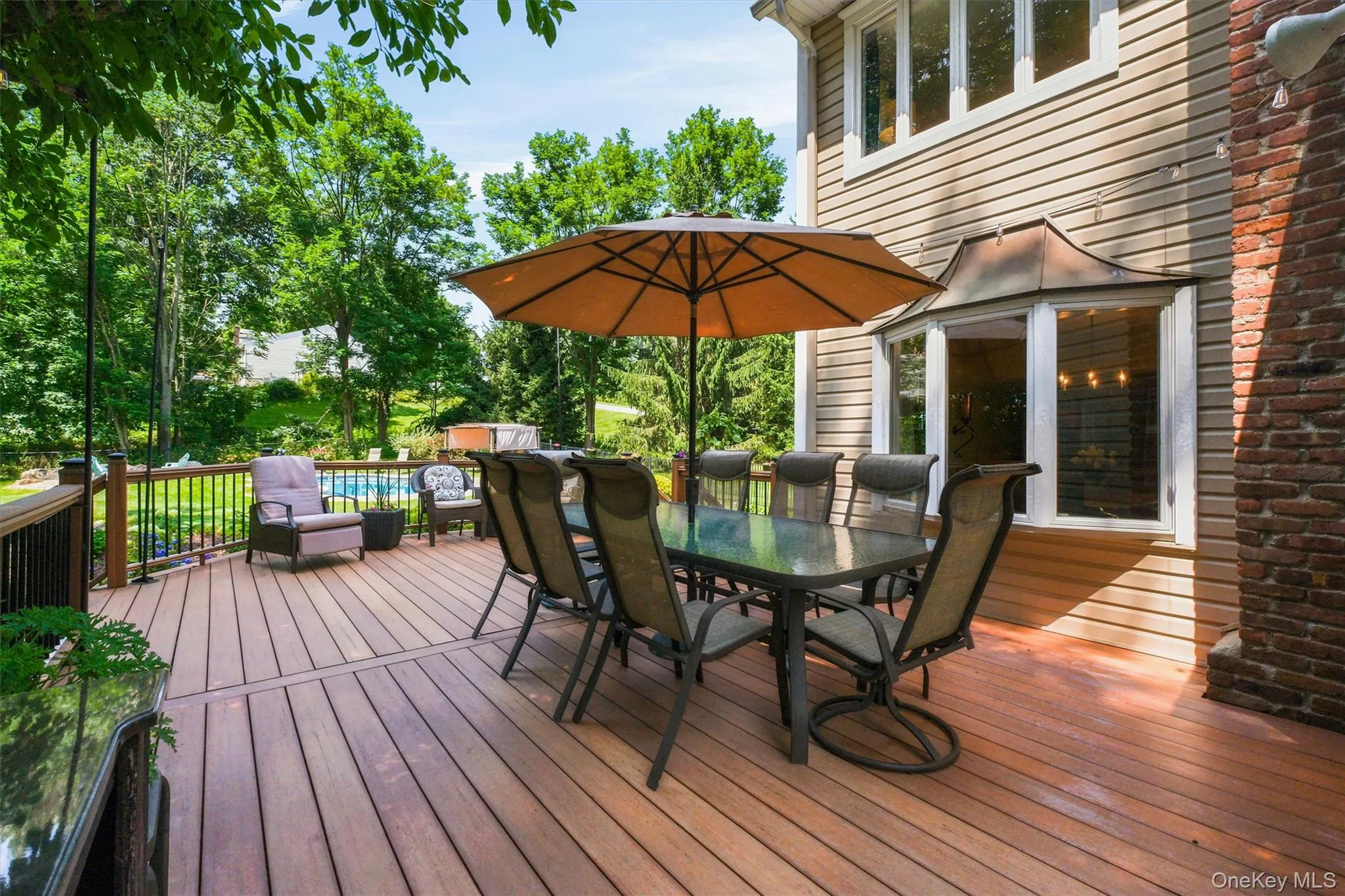Large spacious deck that leads from kitchen to beautiful outdoor grounds & pool - a mini oasis Large spacious deck that leads from kitchen to beautiful outdoor grounds & pool - a mini oasis