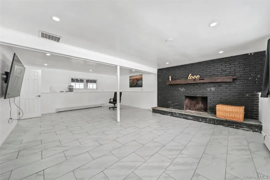 Lower-Level w/ fireplace newly tiled and painted Lower-Level w/ fireplace newly tiled and painted