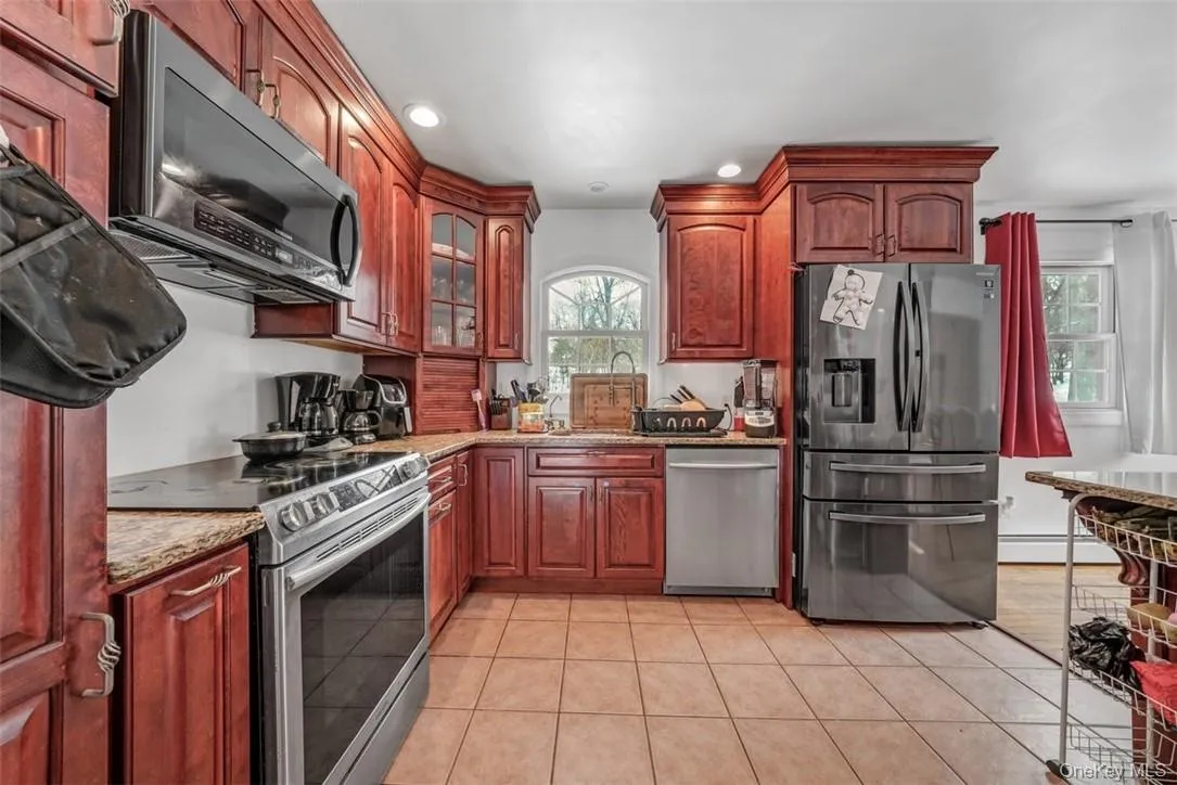 Kitchen with new refrigerator and new microwave Kitchen with new refrigerator and new microwave