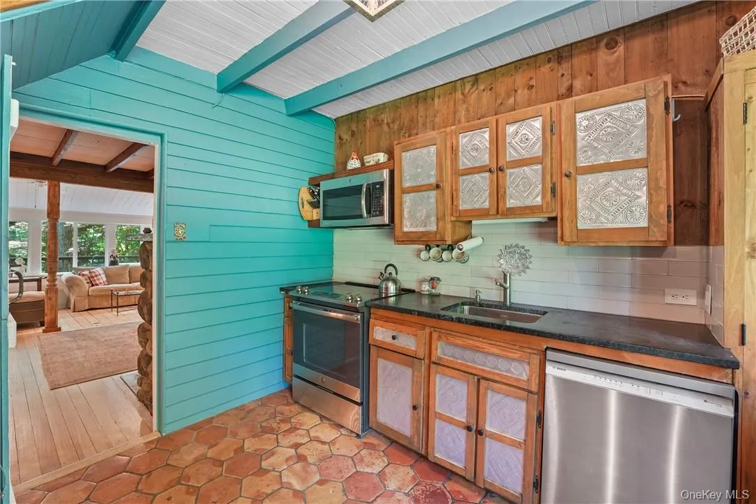 Kitchen with stainless steel appliances, vaulted ceiling with beams Kitchen with stainless steel appliances, vaulted ceiling with beams