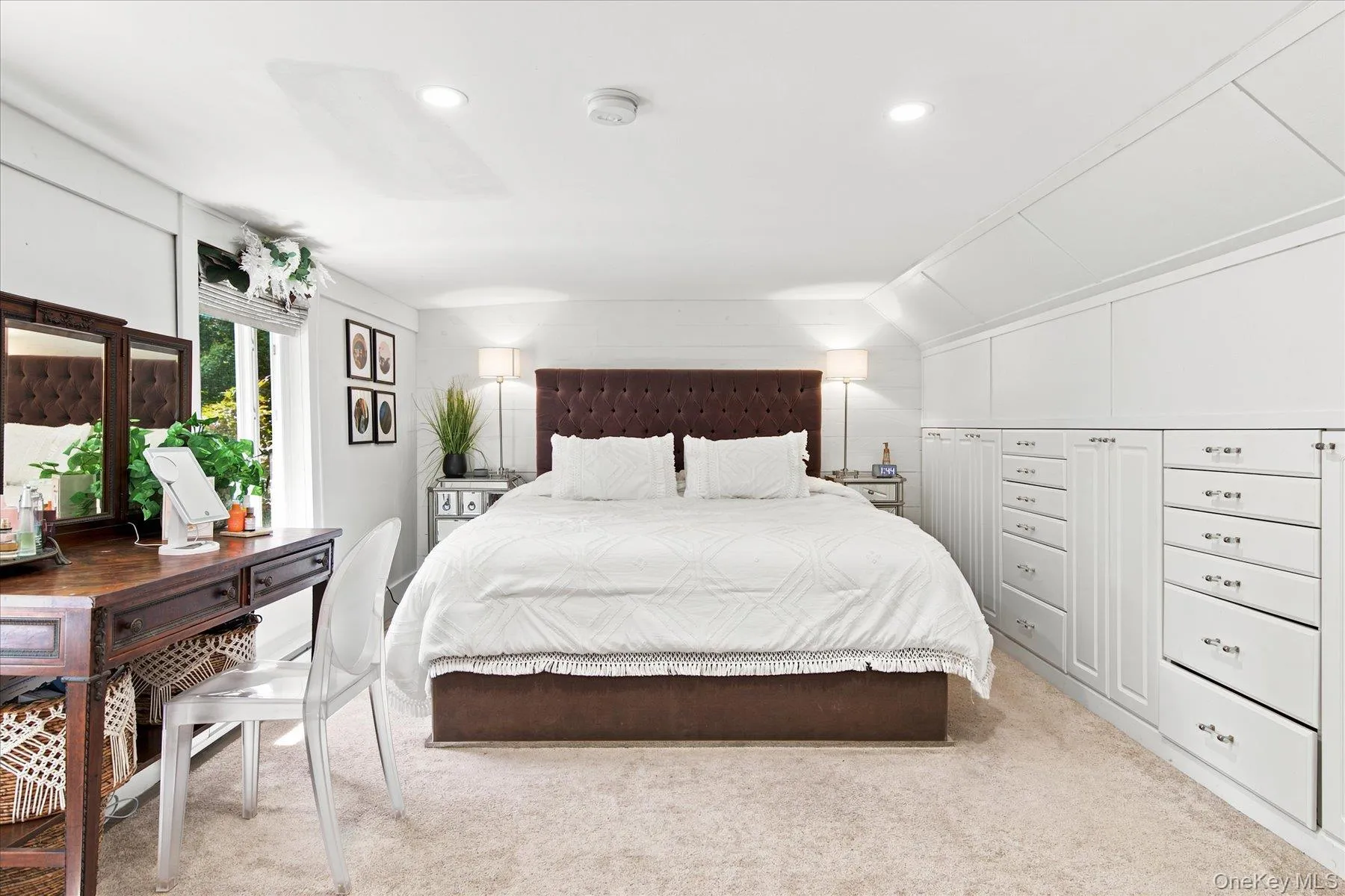 Primary bedroom with built in dressers and brand new oversized pella windows Primary bedroom with built in dressers and brand new oversized pella windows