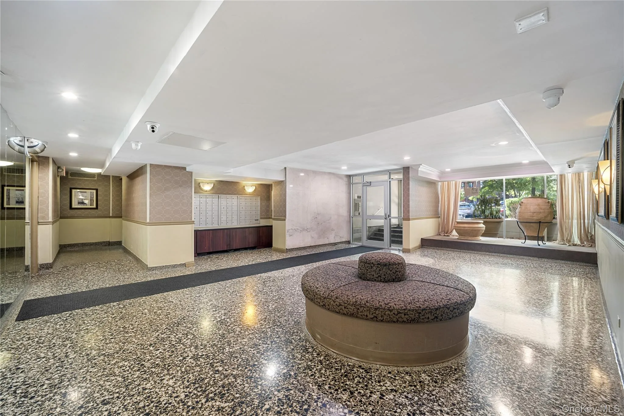 Spacious lobby featuring polished terrazzo flooring and ample natural light from extensive window walls Spacious lobby featuring polished terrazzo flooring and ample natural light from extensive window walls