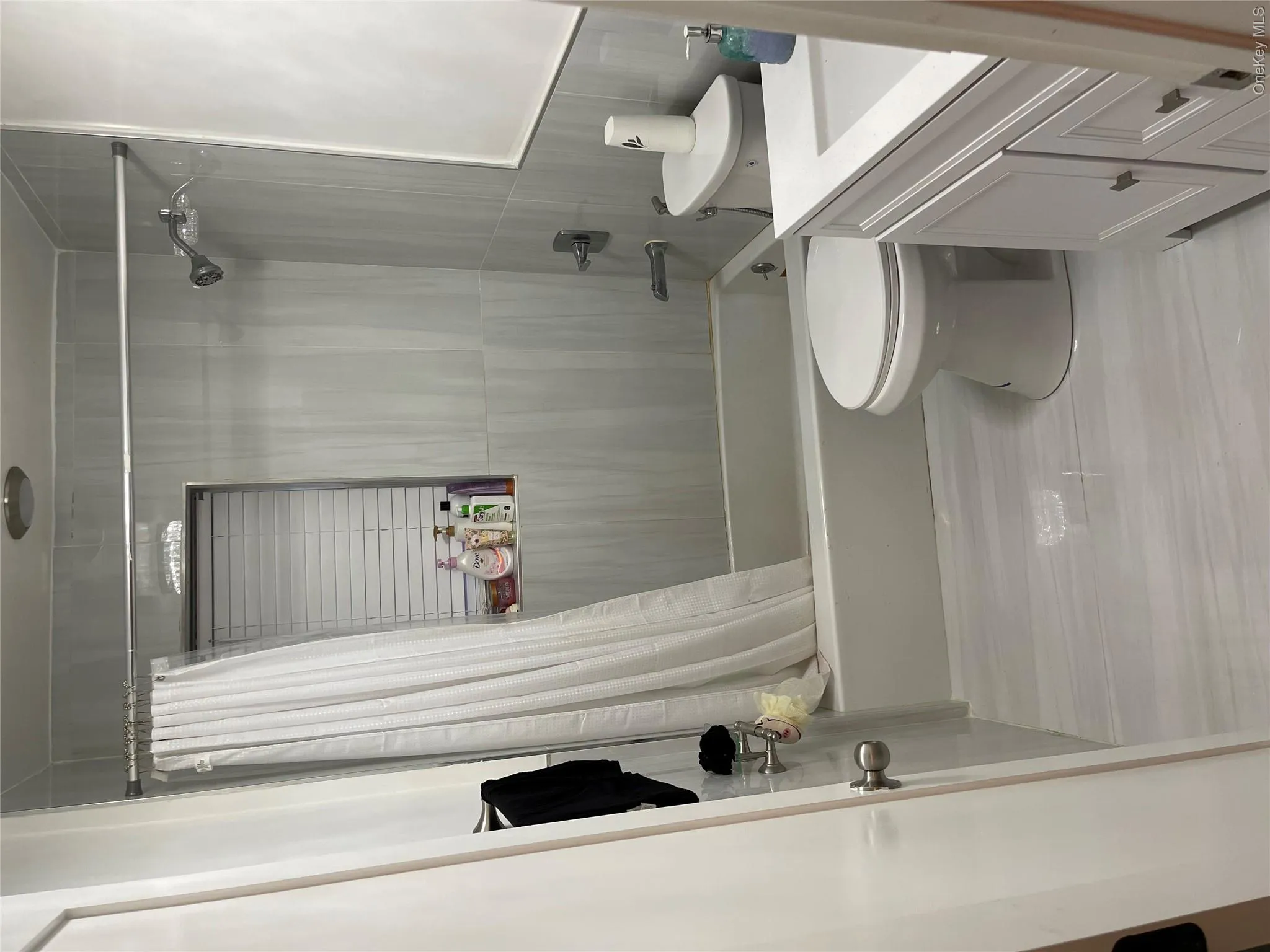 Bathroom featuring shower / bathtub combination with curtain and vanity Bathroom featuring shower / bathtub combination with curtain and vanity