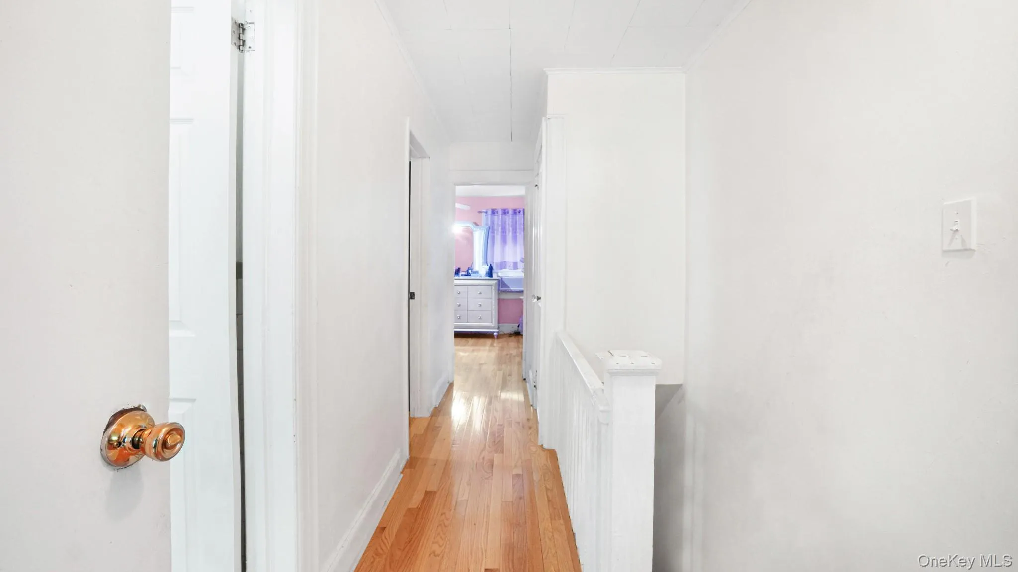 Hall featuring crown molding and light wood-style floors Hall featuring crown molding and light wood-style floors