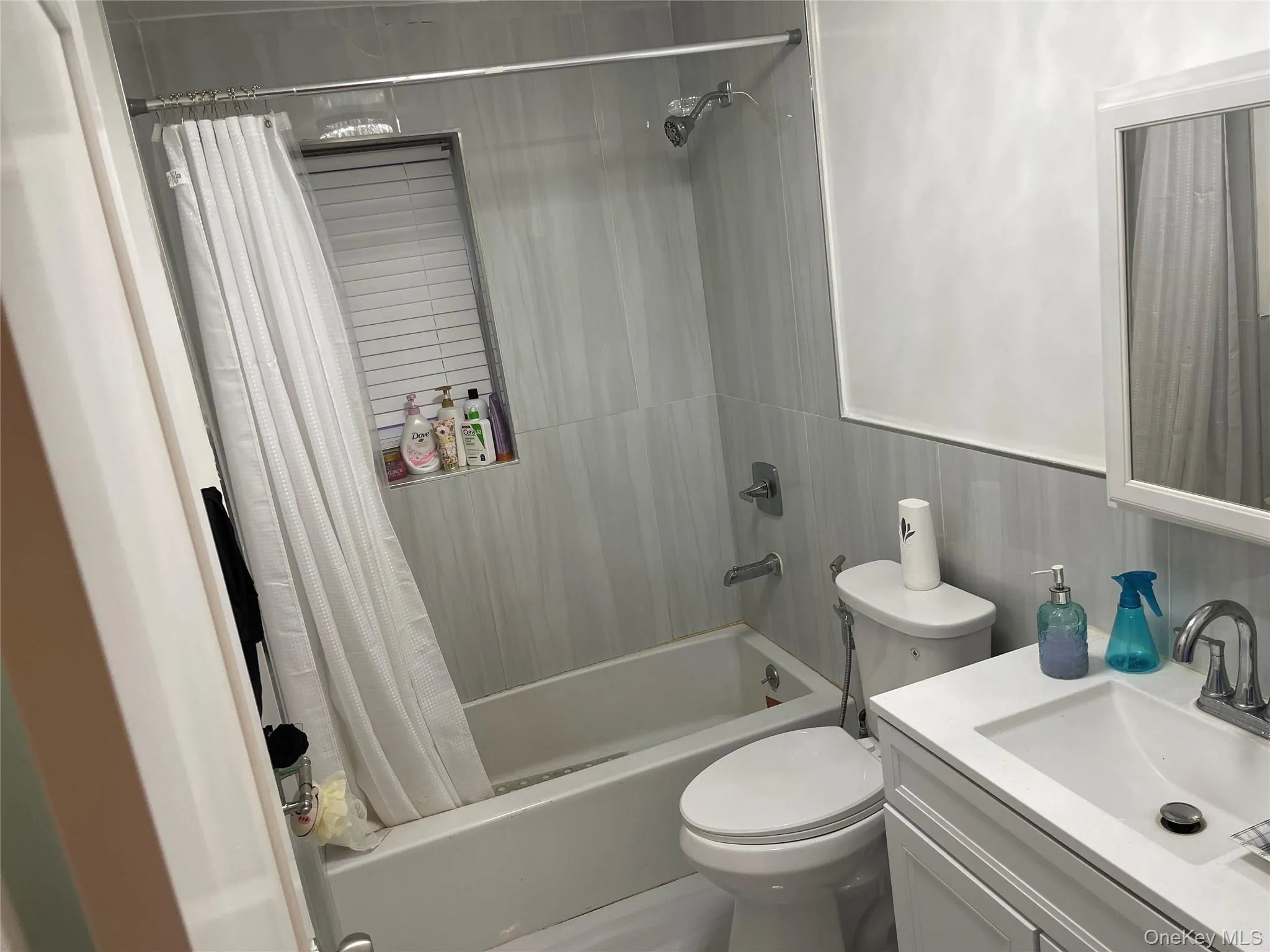 Full bathroom with shower / bath combo with shower curtain and vanity Full bathroom with shower / bath combo with shower curtain and vanity