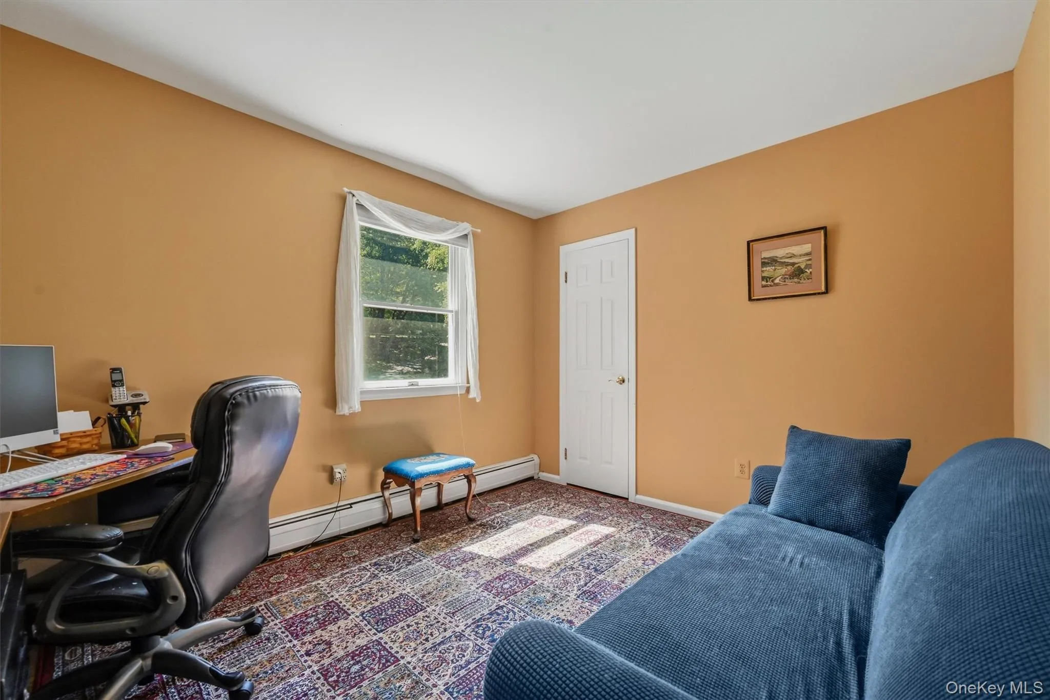 Room featuring a single window with white trim, a white paneled door, light-colored walls, and patterned carpeting Room featuring a single window with white trim, a white paneled door, light-colored walls, and patterned carpeting