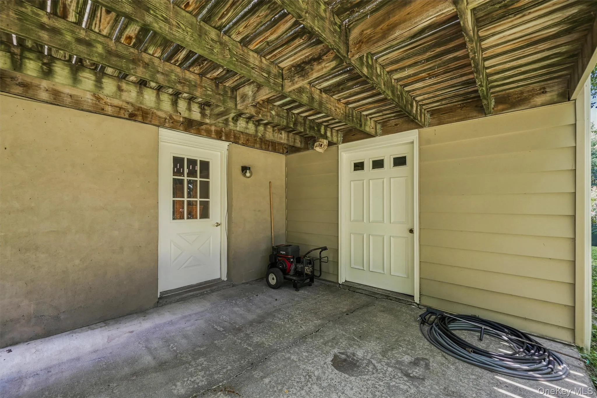 Convenient covered entry featuring easy access to additional storage and outdoor utility space. Convenient covered entry featuring easy access to additional storage and outdoor utility space.