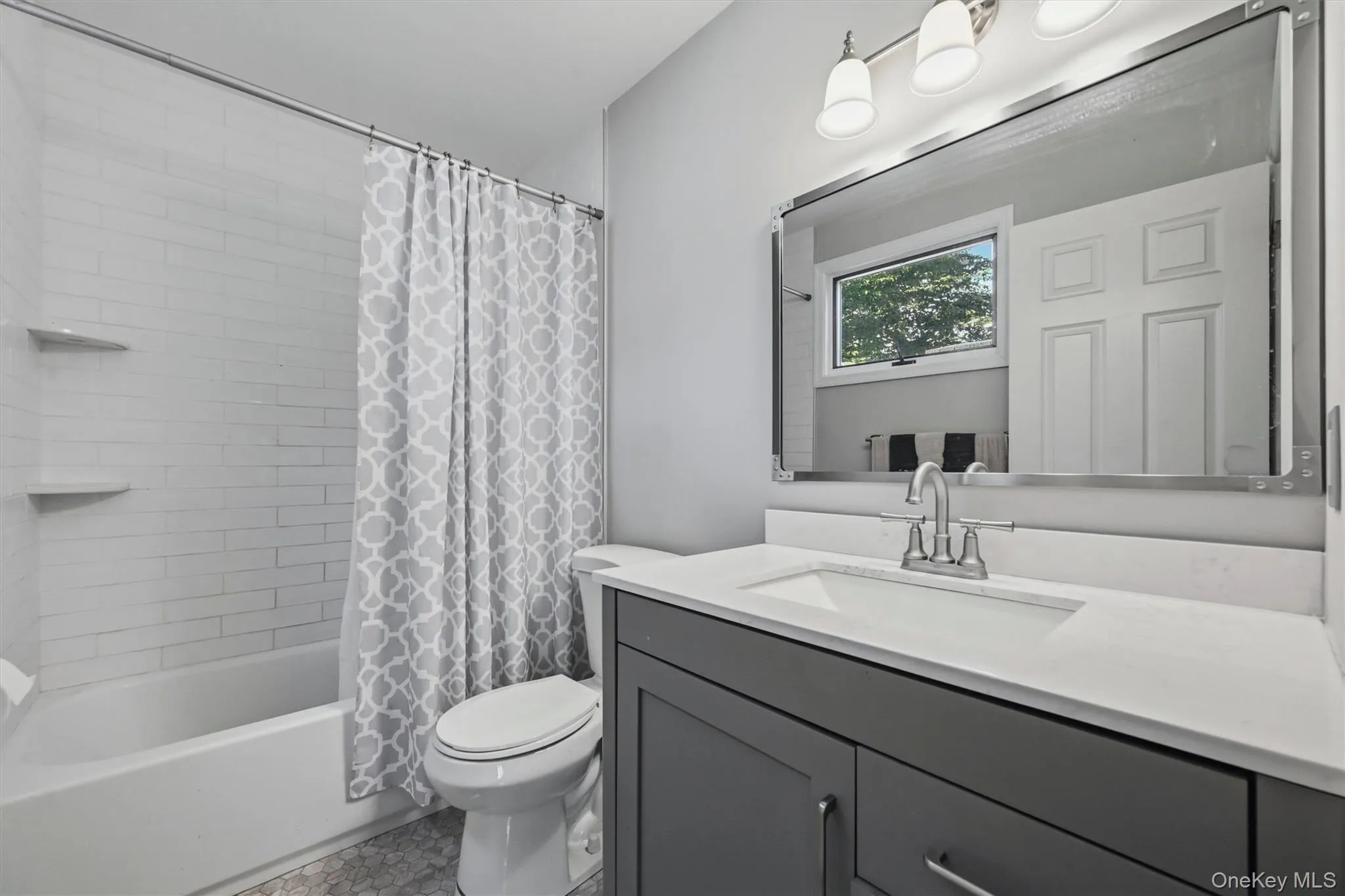 Bathroom featuring a white bathtub with subway tile surround and integrated shelves Bathroom featuring a white bathtub with subway tile surround and integrated shelves