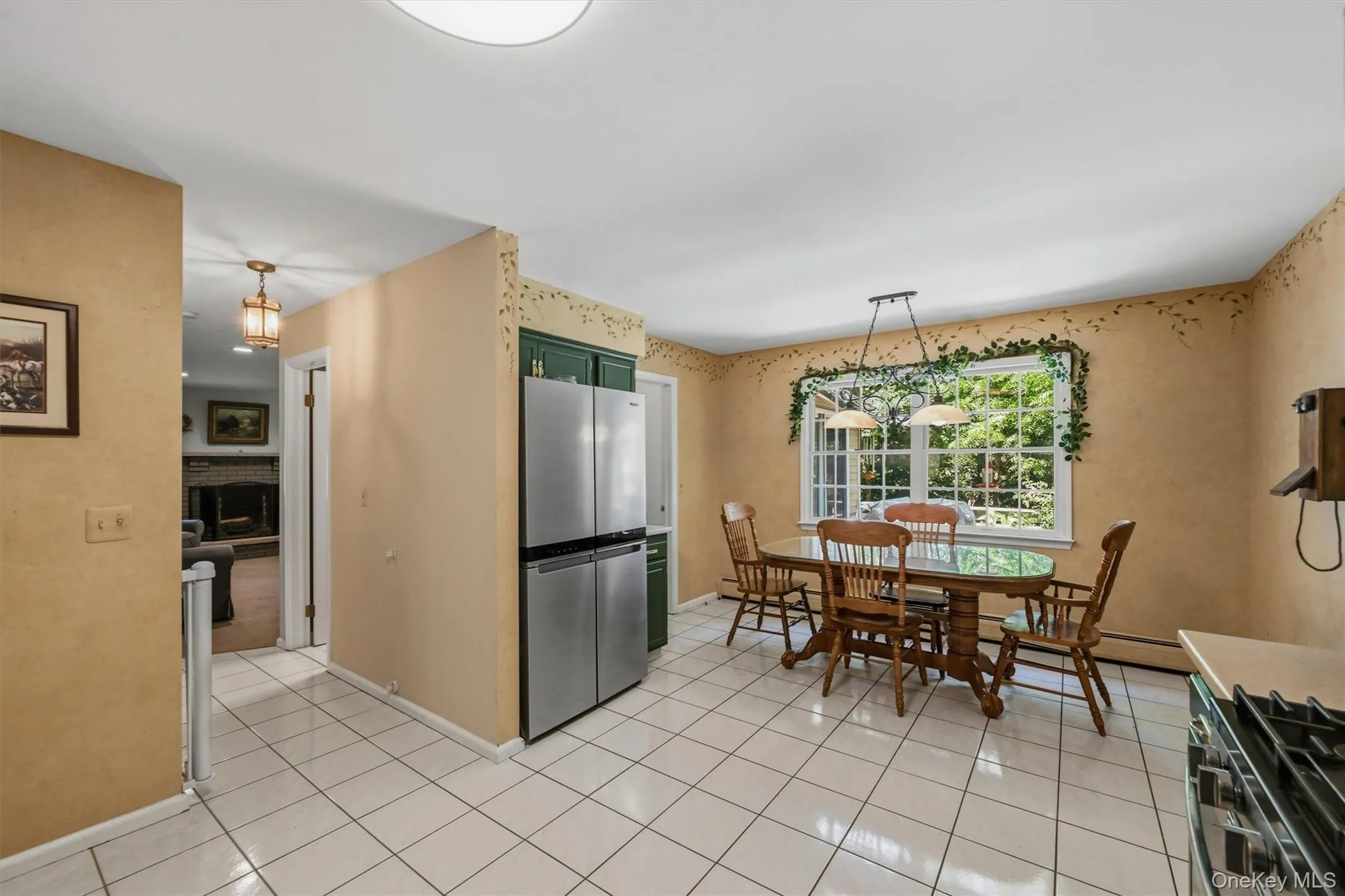 Bright eat-in kitchen with tile flooring, a large dining area, and oversized windows. Bright eat-in kitchen with tile flooring, a large dining area, and oversized windows.