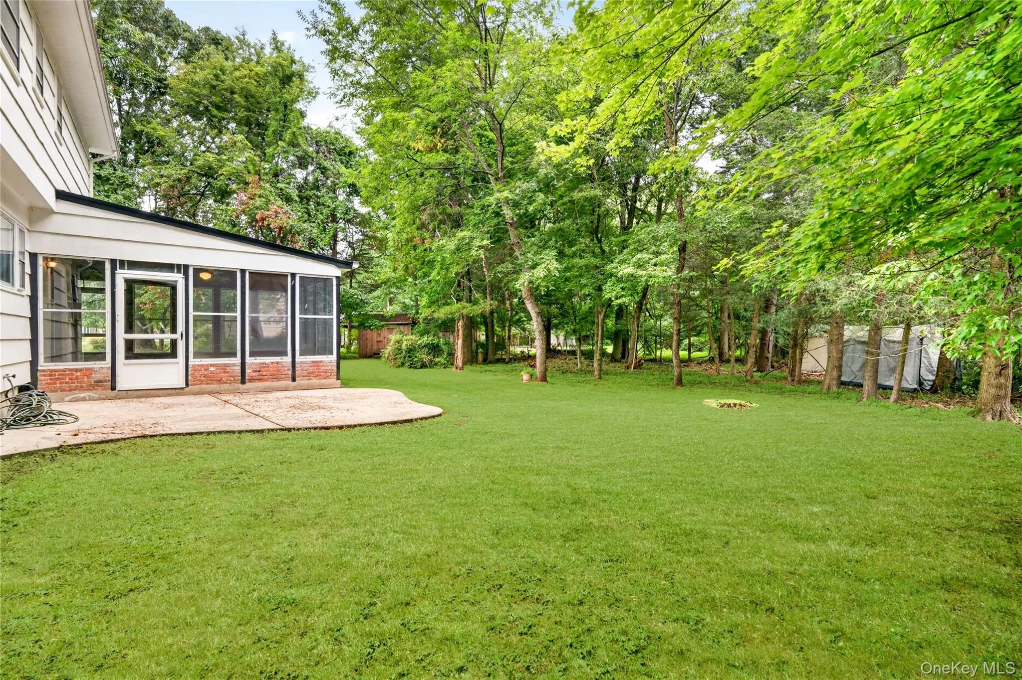 Expansive green lawn extending to a treed perimeter Expansive green lawn extending to a treed perimeter