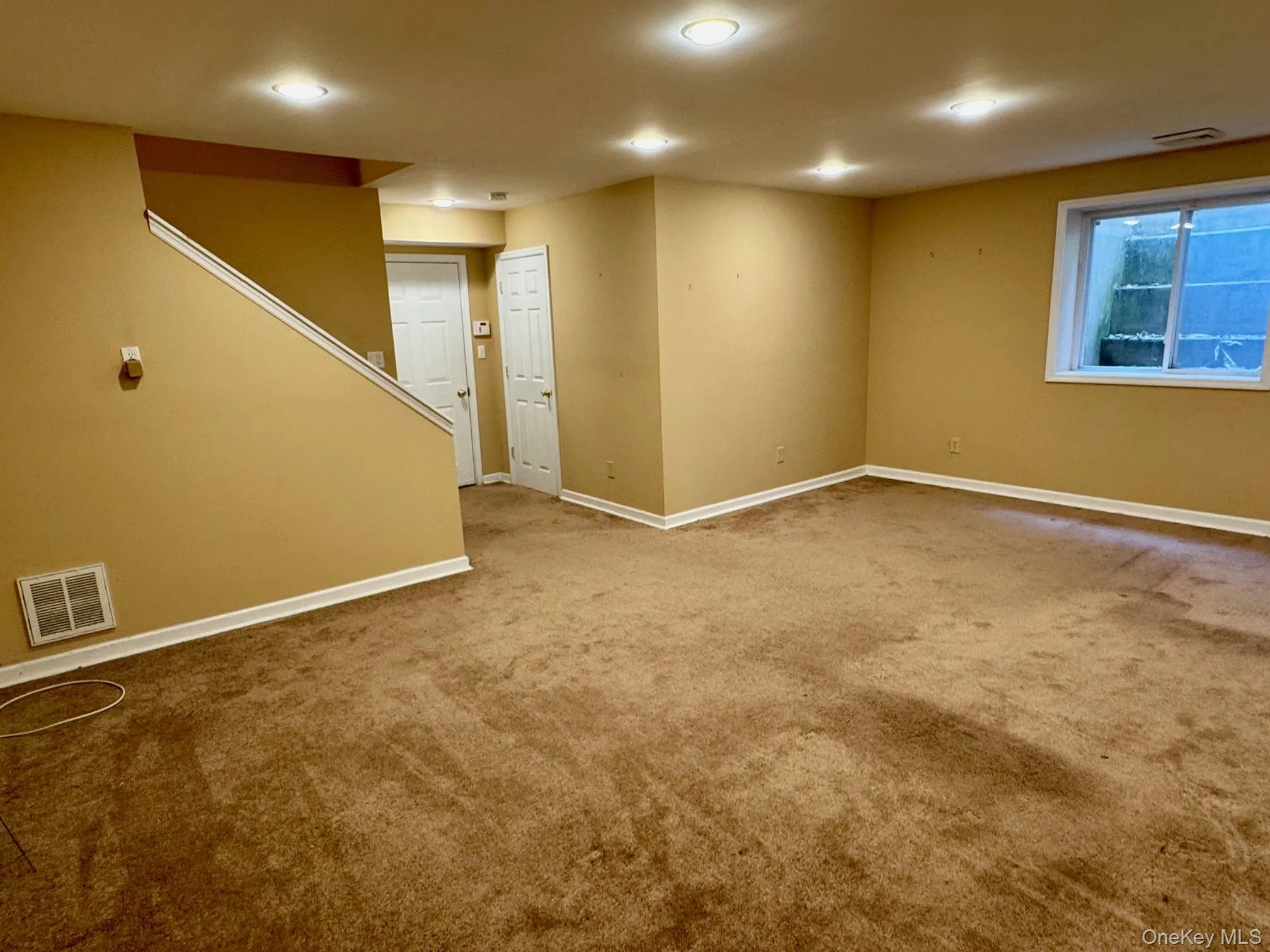 Carpeted empty room featuring baseboards and recessed lighting Carpeted empty room featuring baseboards and recessed lighting