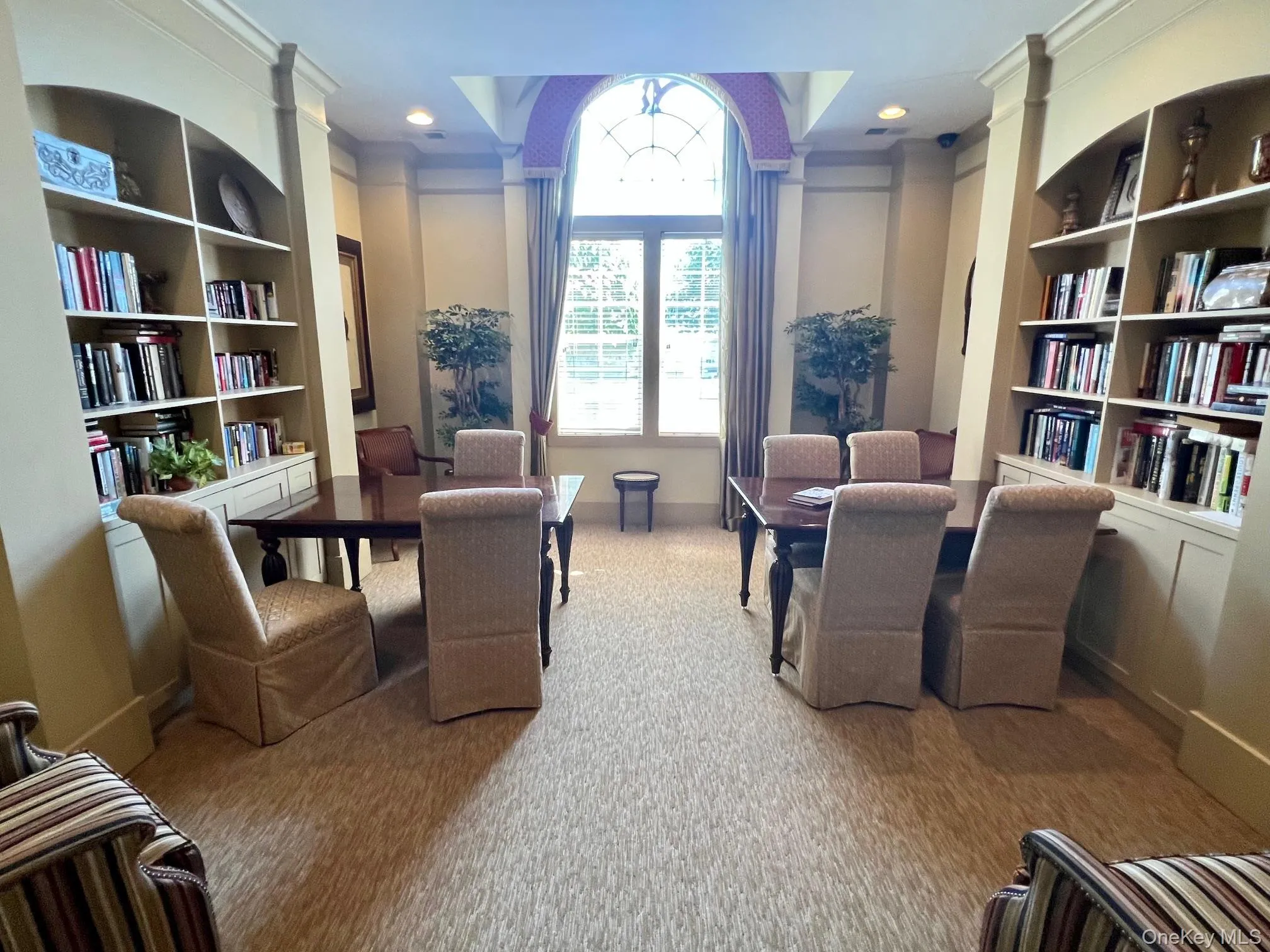 Living area featuring carpet flooring, built in features, and crown molding Living area featuring carpet flooring, built in features, and crown molding