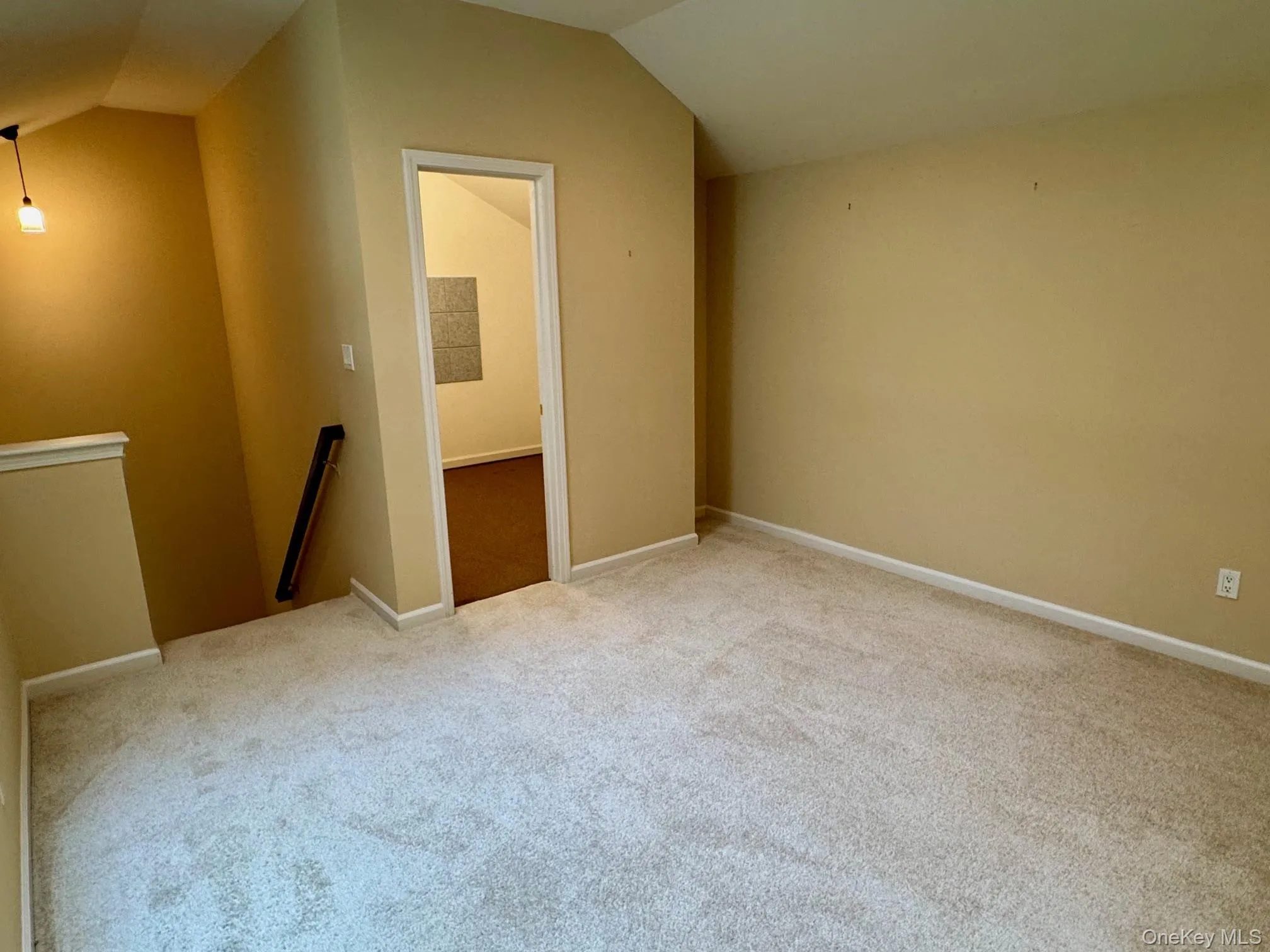 Bonus room featuring lofted ceiling and carpet Bonus room featuring lofted ceiling and carpet