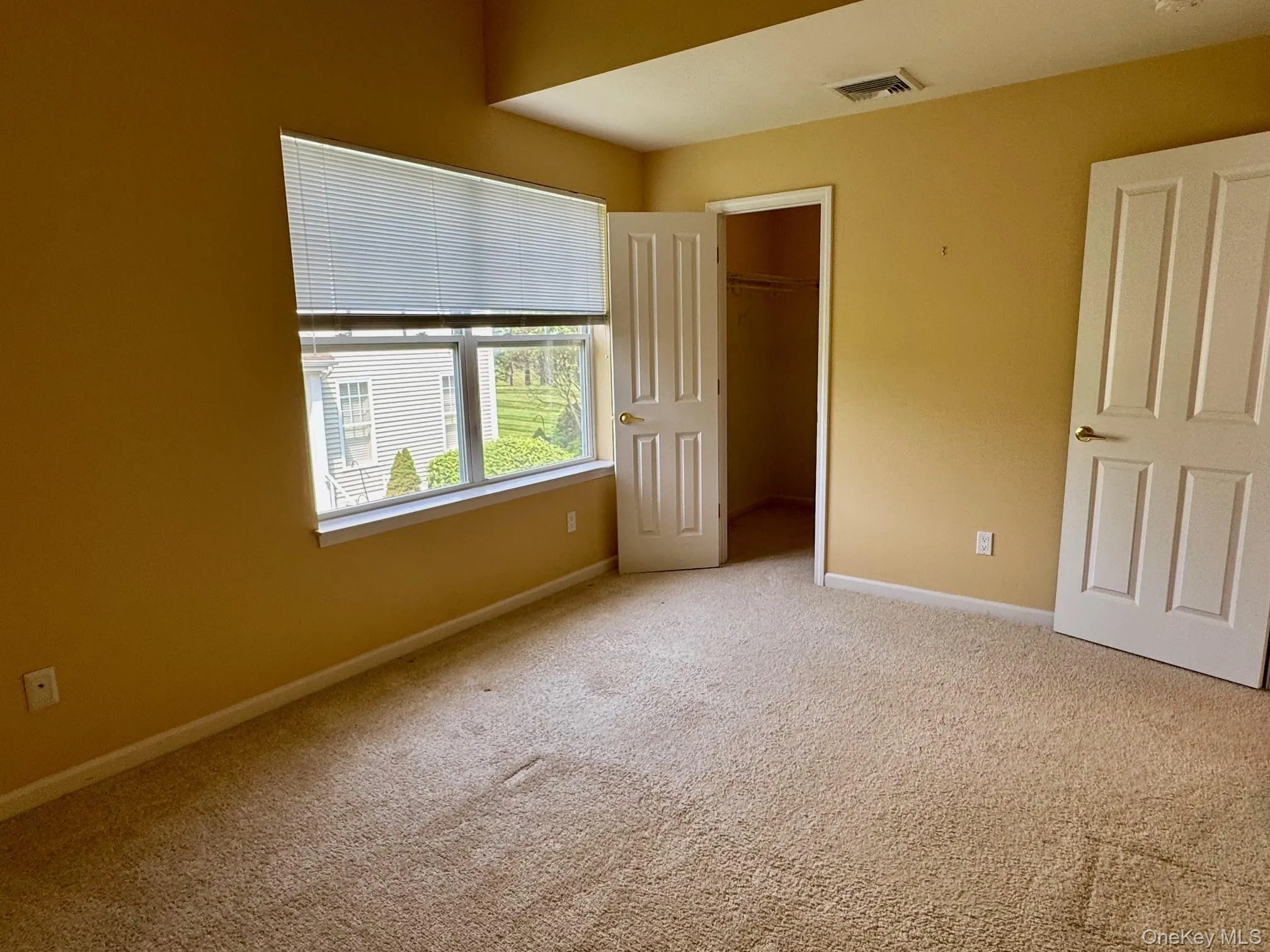 Unfurnished bedroom featuring carpet flooring and a closet Unfurnished bedroom featuring carpet flooring and a closet