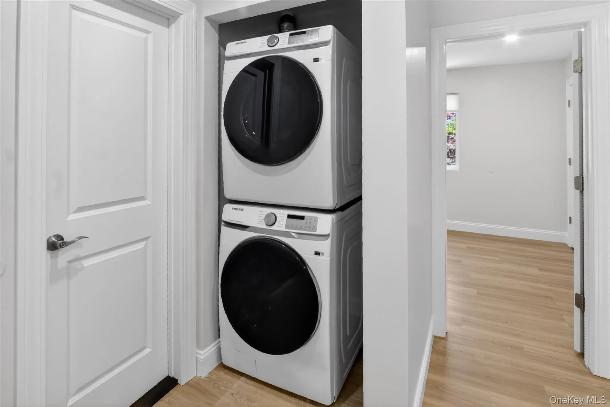 Dedicated laundry area featuring a stacked washer and dryer unit Dedicated laundry area featuring a stacked washer and dryer unit