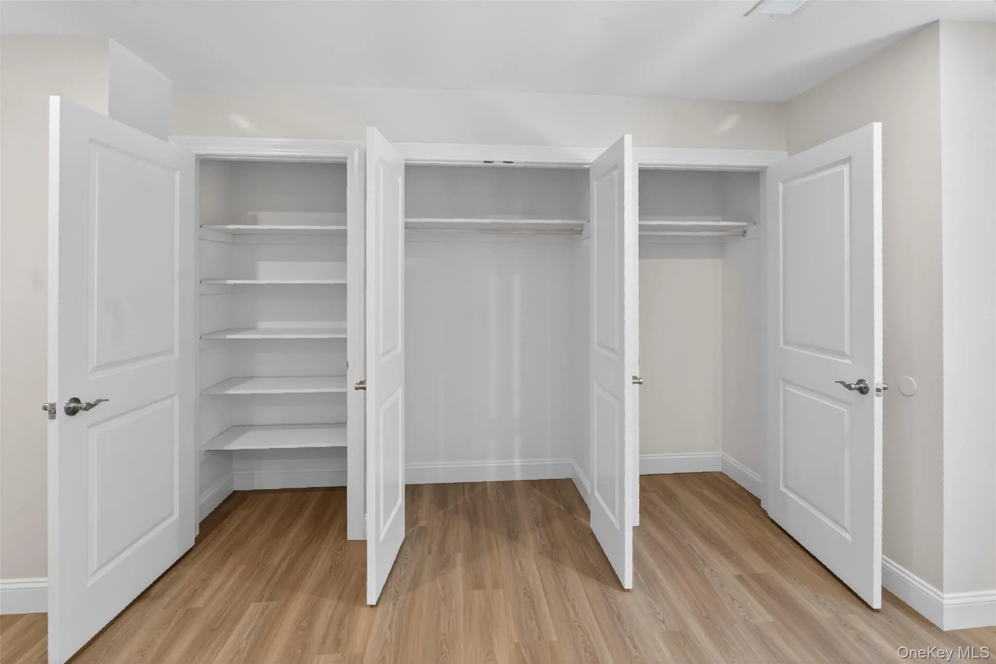 White paneled doors opening to three spacious built-in closets White paneled doors opening to three spacious built-in closets