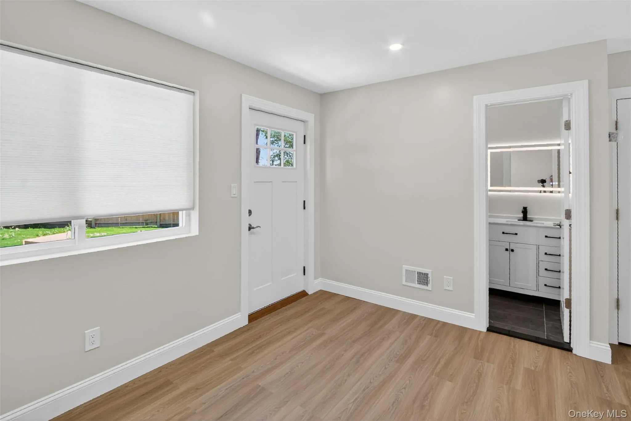 Light wood-finish flooring complements the neutral wall color Light wood-finish flooring complements the neutral wall color