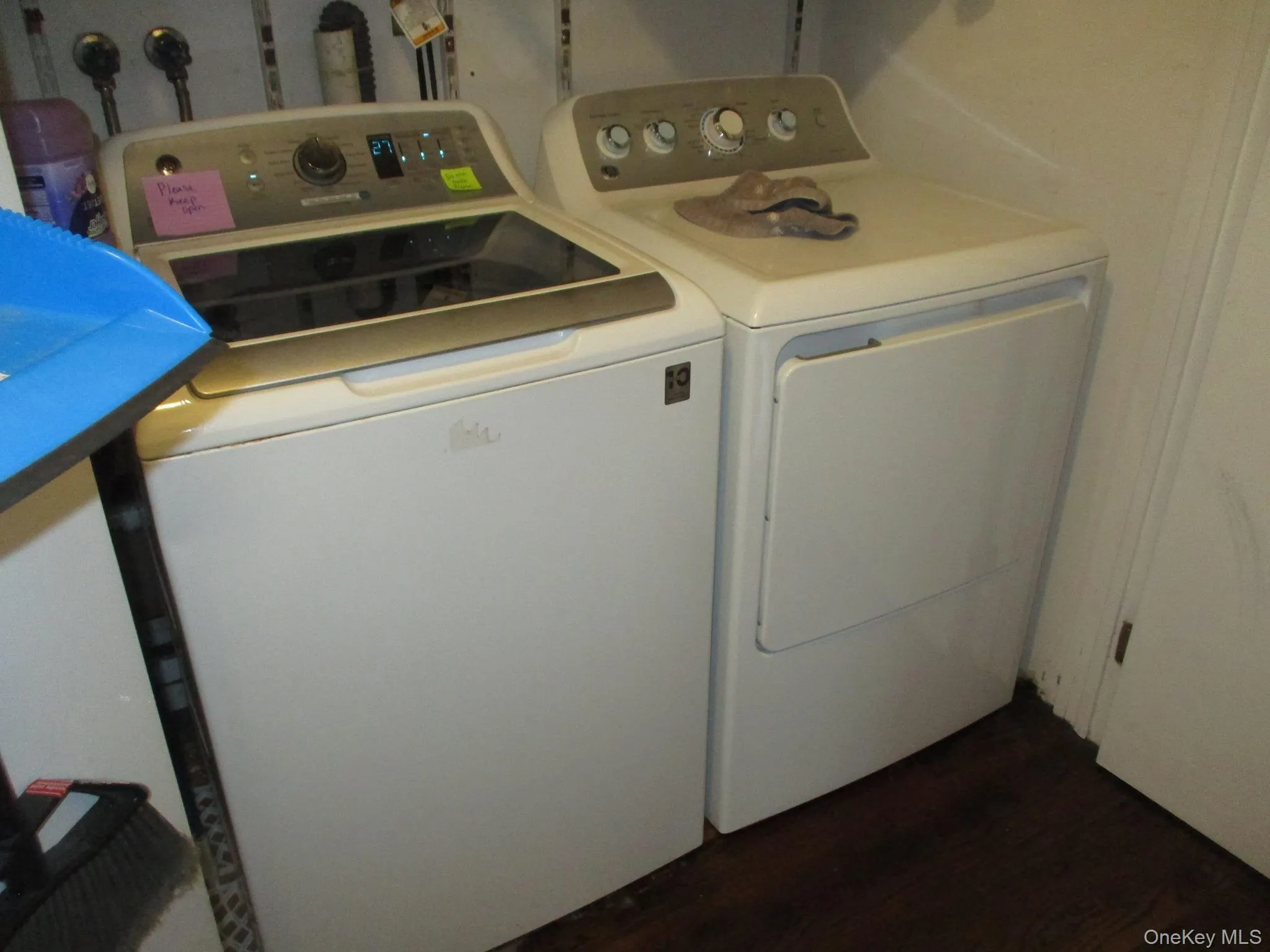 Clothes washing area featuring laundry area, dark wood-style floors, and washing machine and dryer Clothes washing area featuring laundry area, dark wood-style floors, and washing machine and dryer