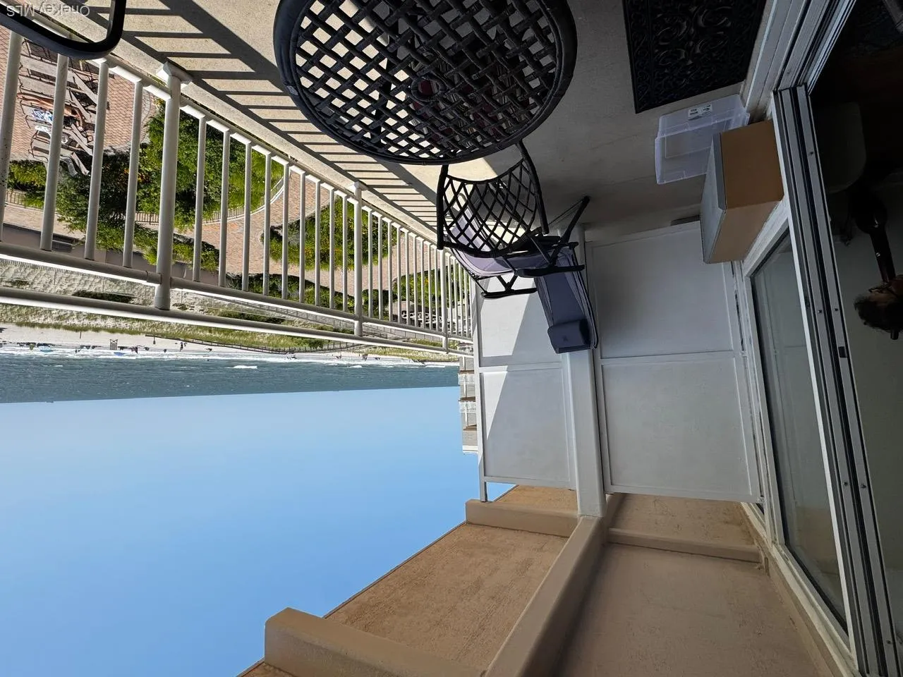 Balcony with view of water and beach Balcony with view of water and beach