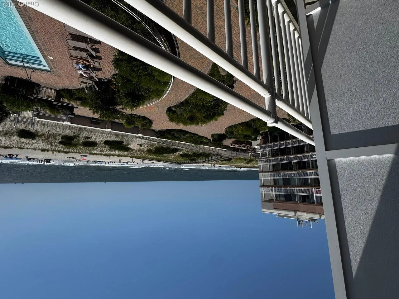 Balcony with view of water and beach and view of pool Balcony with view of water and beach and view of pool