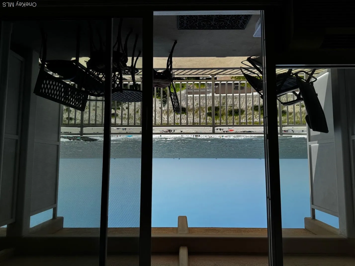 Balcony featuring view of water and beach Balcony featuring view of water and beach