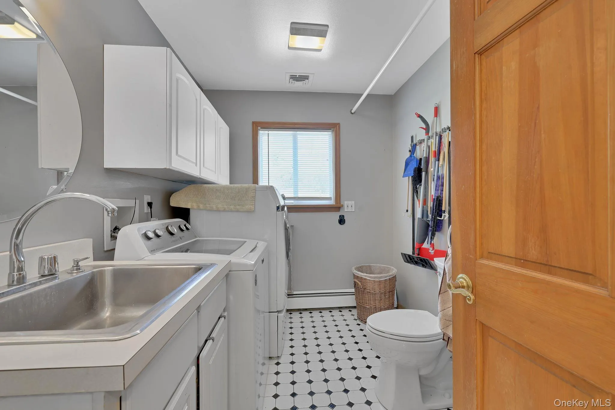 Thoughtfully positioned across from the office or potential fifth bedroom, the laundry room includes a convenient half bath, adding both comfort and practicality to the home's layout Thoughtfully positioned across from the office or potential fifth bedroom, the laundry room includes a convenient half bath, adding both comfort and practicality to the home's layout