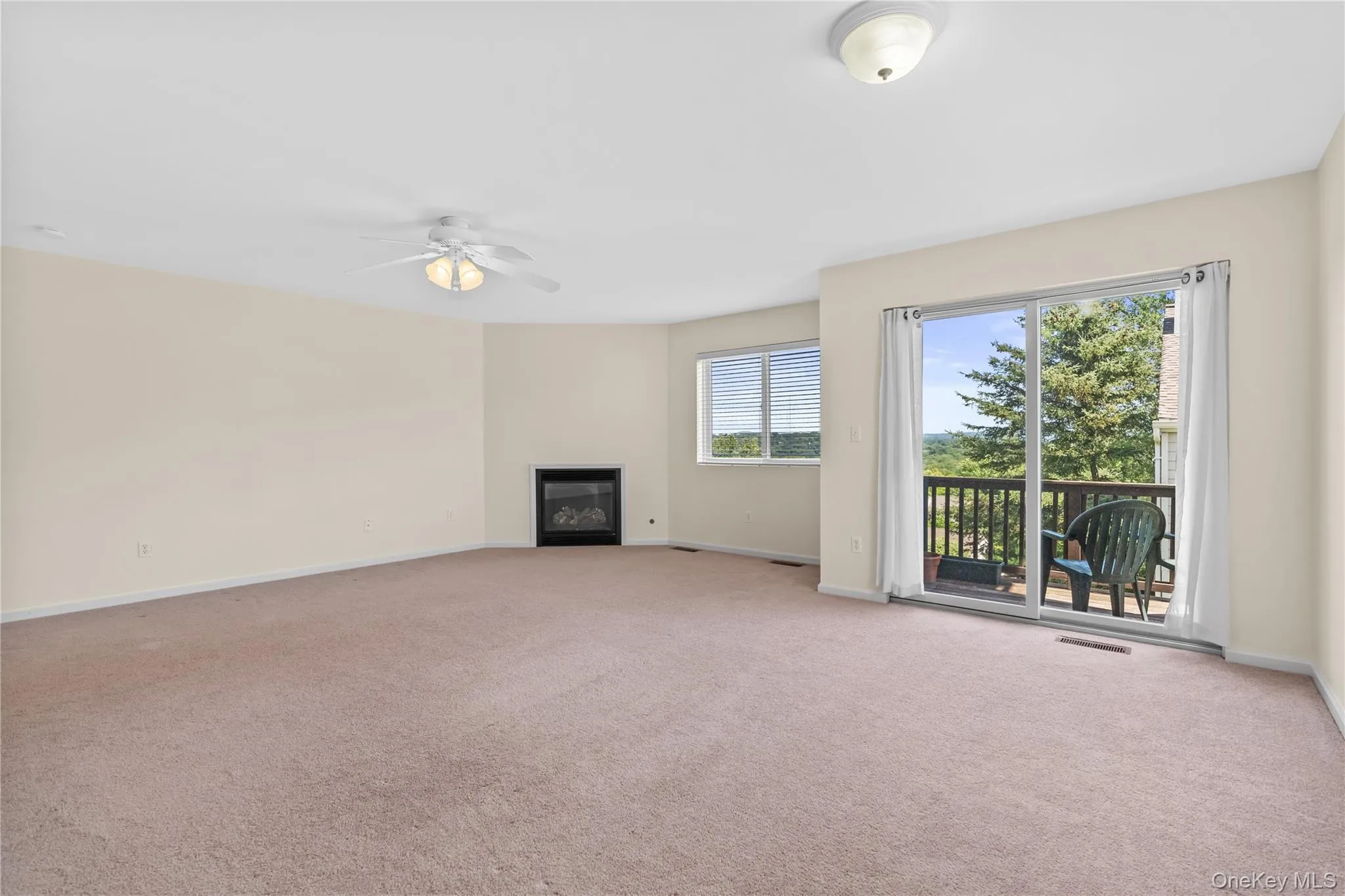 Living room features gas fireplace and slider to deck Living room features gas fireplace and slider to deck