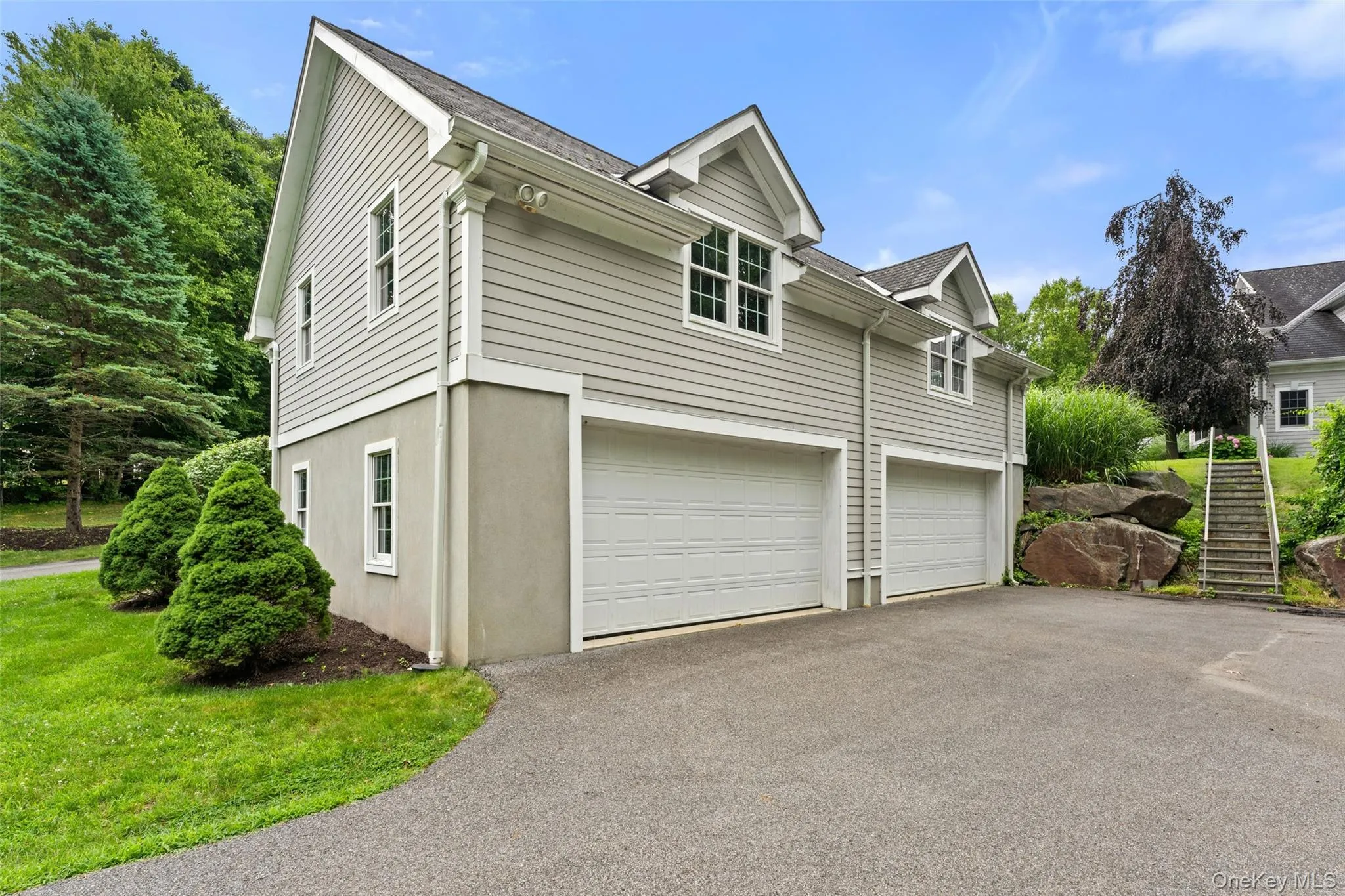Four-Car garage with parking level measuring 1,162 square feet. The expansive unfinished space above the parking level measures 1,162 square feet. Outside stairs to Main home easy access to basement. Four-Car garage with parking level measuring 1,162 square feet. The expansive unfinished space above the parking level measures 1,162 square feet. Outside stairs to Main home easy access to basement.