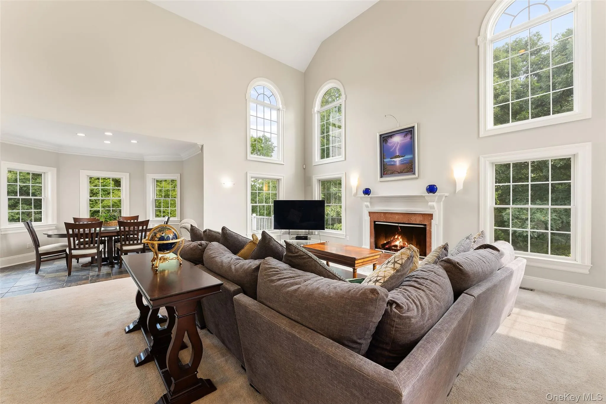 The Family Room features soaring ceilings, exceptional light, fireplace and opens into the Kitchen, Dining Area and Game Room. The Family Room features soaring ceilings, exceptional light, fireplace and opens into the Kitchen, Dining Area and Game Room.