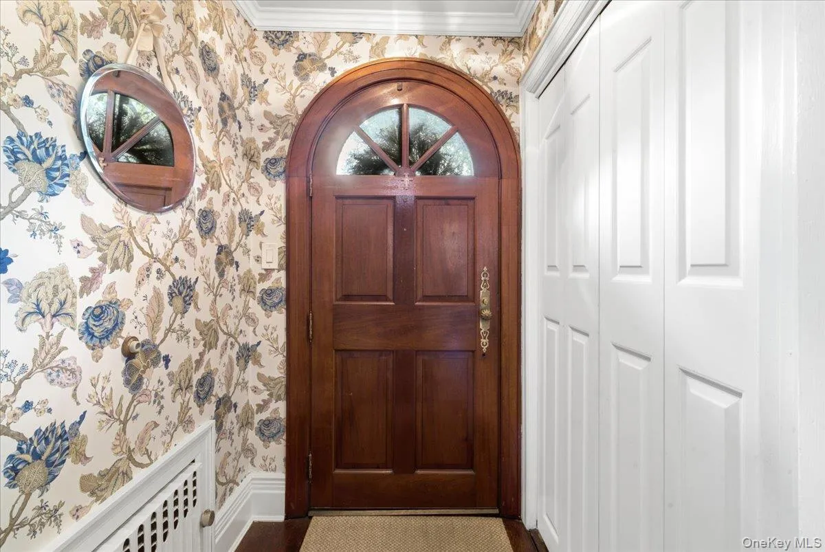 Charming Vestibule with wallpaper and coat closet Charming Vestibule with wallpaper and coat closet