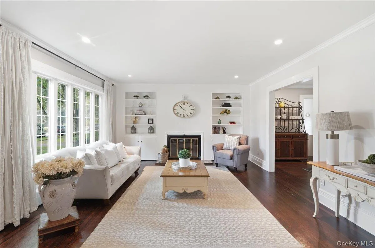 Spacious Living Room with wood burning fireplace and new Pella windows Spacious Living Room with wood burning fireplace and new Pella windows