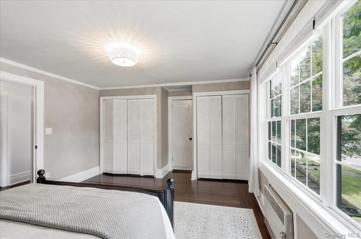 Primary bedroom with beautiful Pella Windows and 2 double closets Primary bedroom with beautiful Pella Windows and 2 double closets