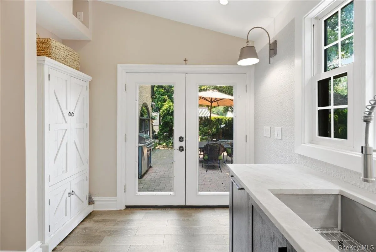 Kitchen with glass doors that lead out to expansive patio and backyard Kitchen with glass doors that lead out to expansive patio and backyard