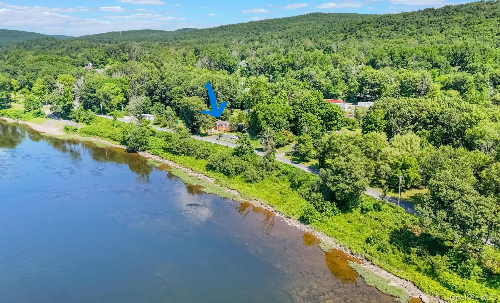 Blue arrow indicates where home and property is in relation to NY side of river Blue arrow indicates where home and property is in relation to NY side of river