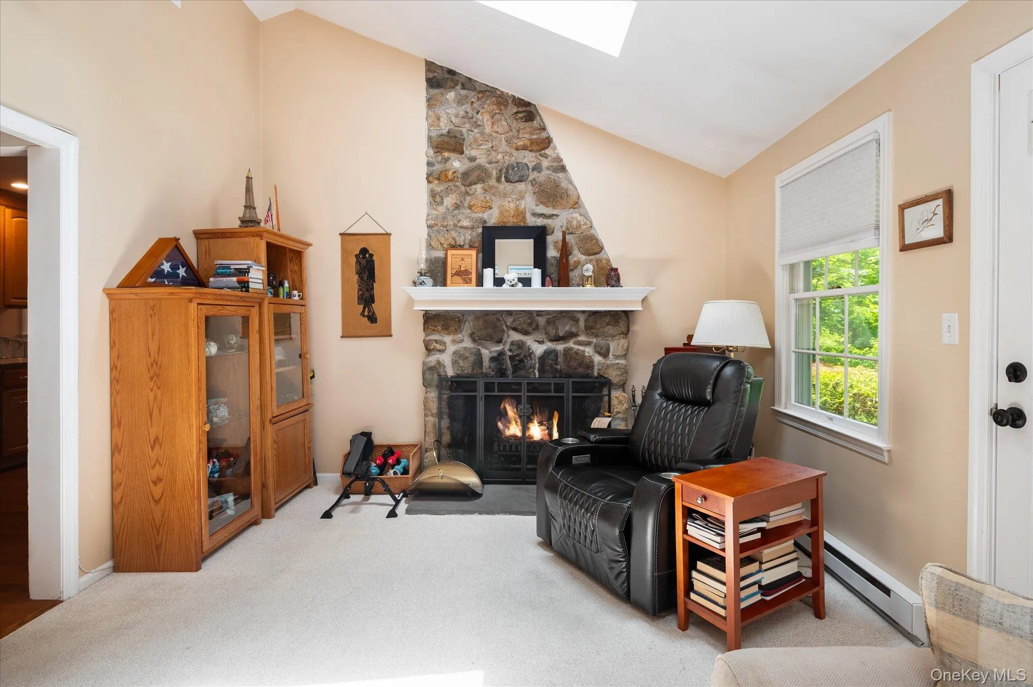 Stone fireplace has an electric insert Stone fireplace has an electric insert