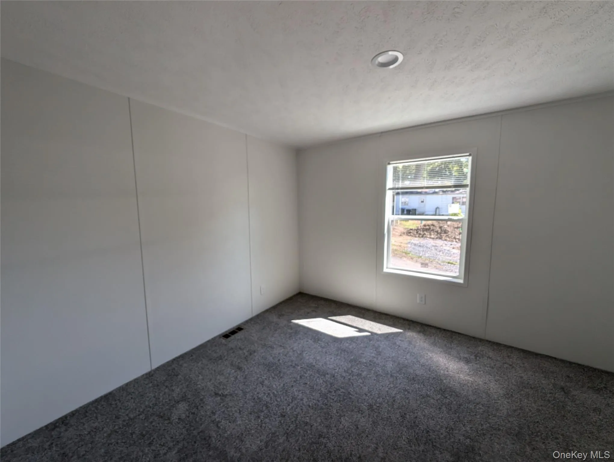 Spare room with carpet and visible vents Spare room with carpet and visible vents