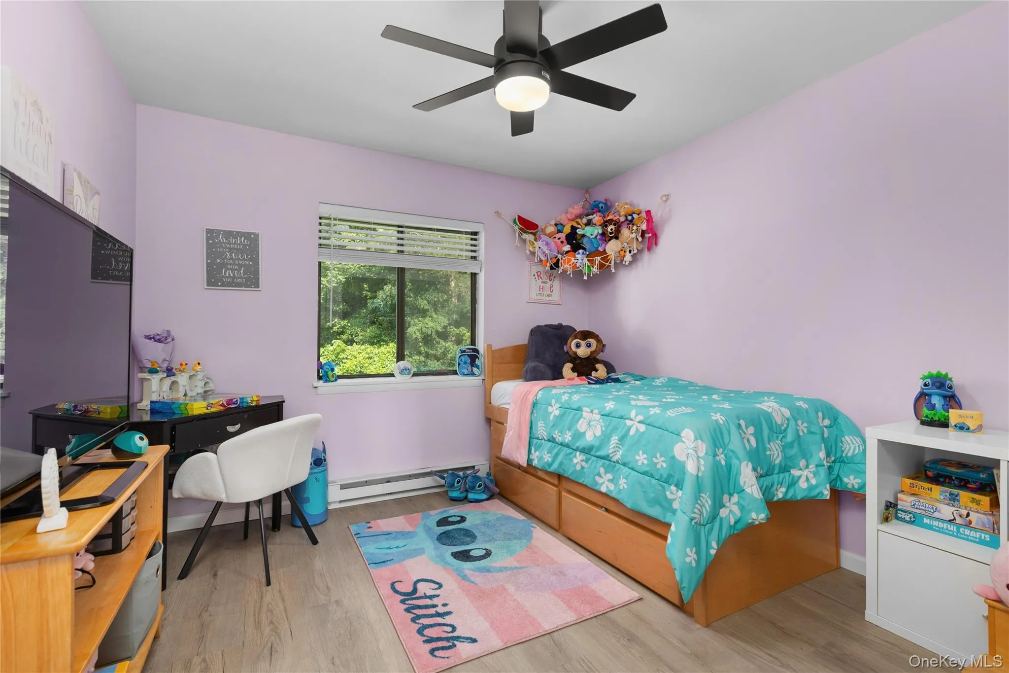 Second bedroom featuring vinyl flooring, ceiling fan, and built in closet Second bedroom featuring vinyl flooring, ceiling fan, and built in closet