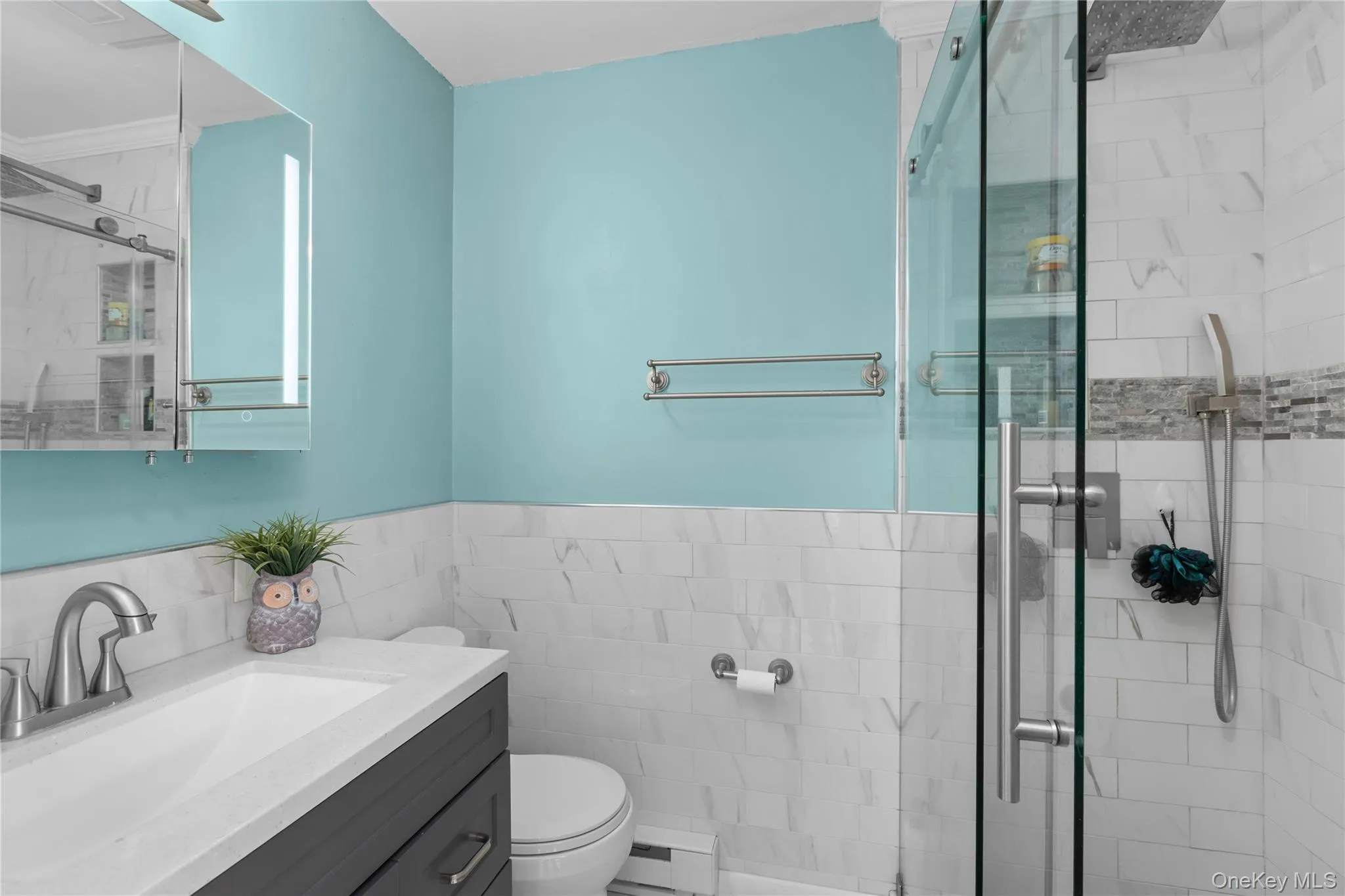 Modern bathroom featuring a glass-enclosed stand-up shower Modern bathroom featuring a glass-enclosed stand-up shower
