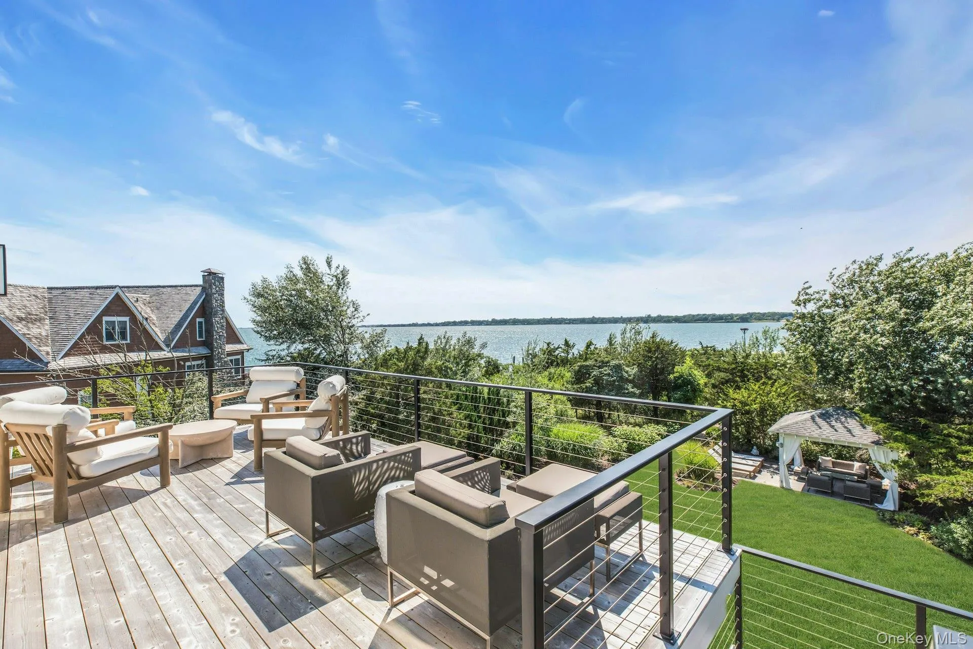Expansive wood-finish deck with cable railing Expansive wood-finish deck with cable railing