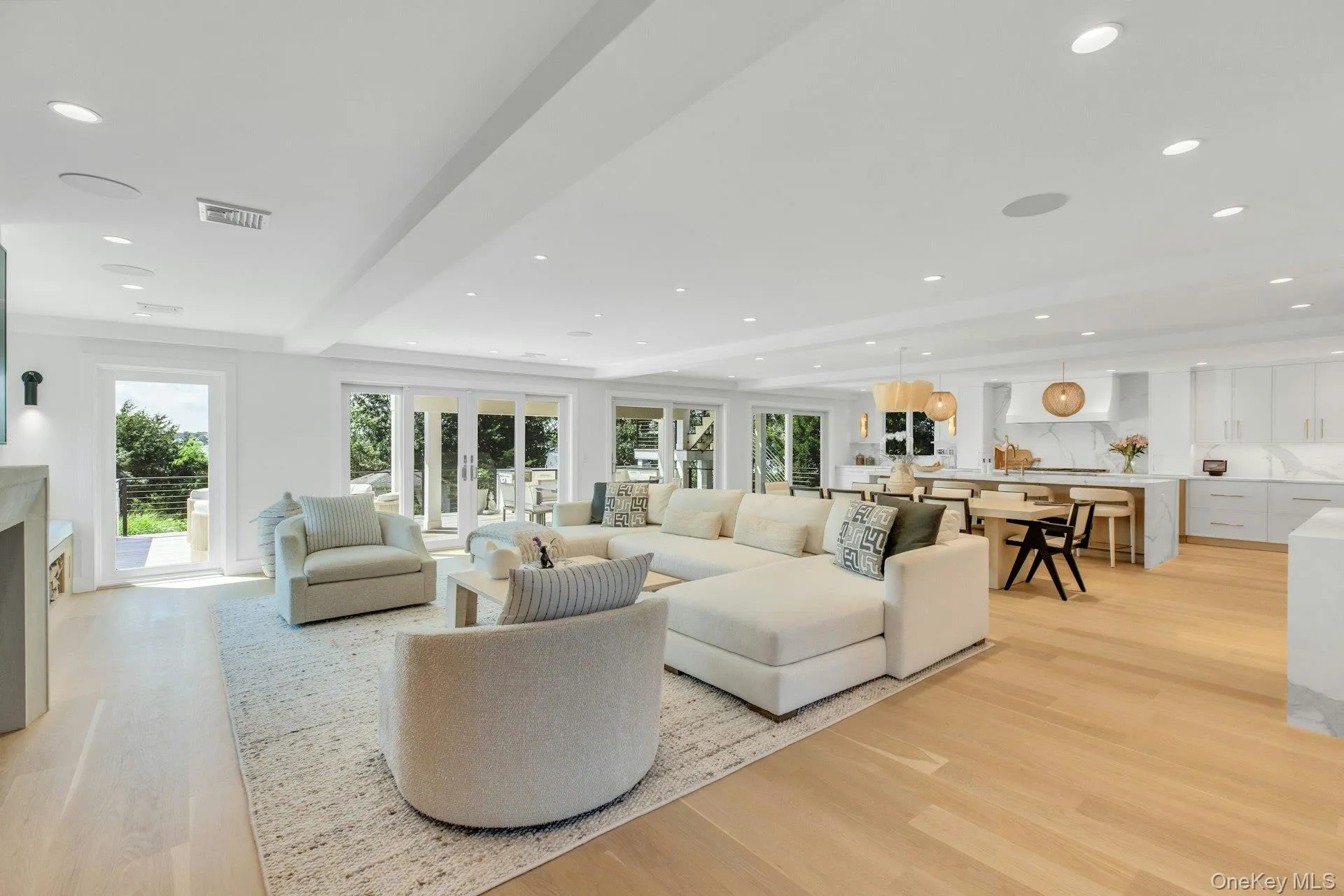 Open-concept living space featuring light wood-finish flooring, recessed lighting Open-concept living space featuring light wood-finish flooring, recessed lighting