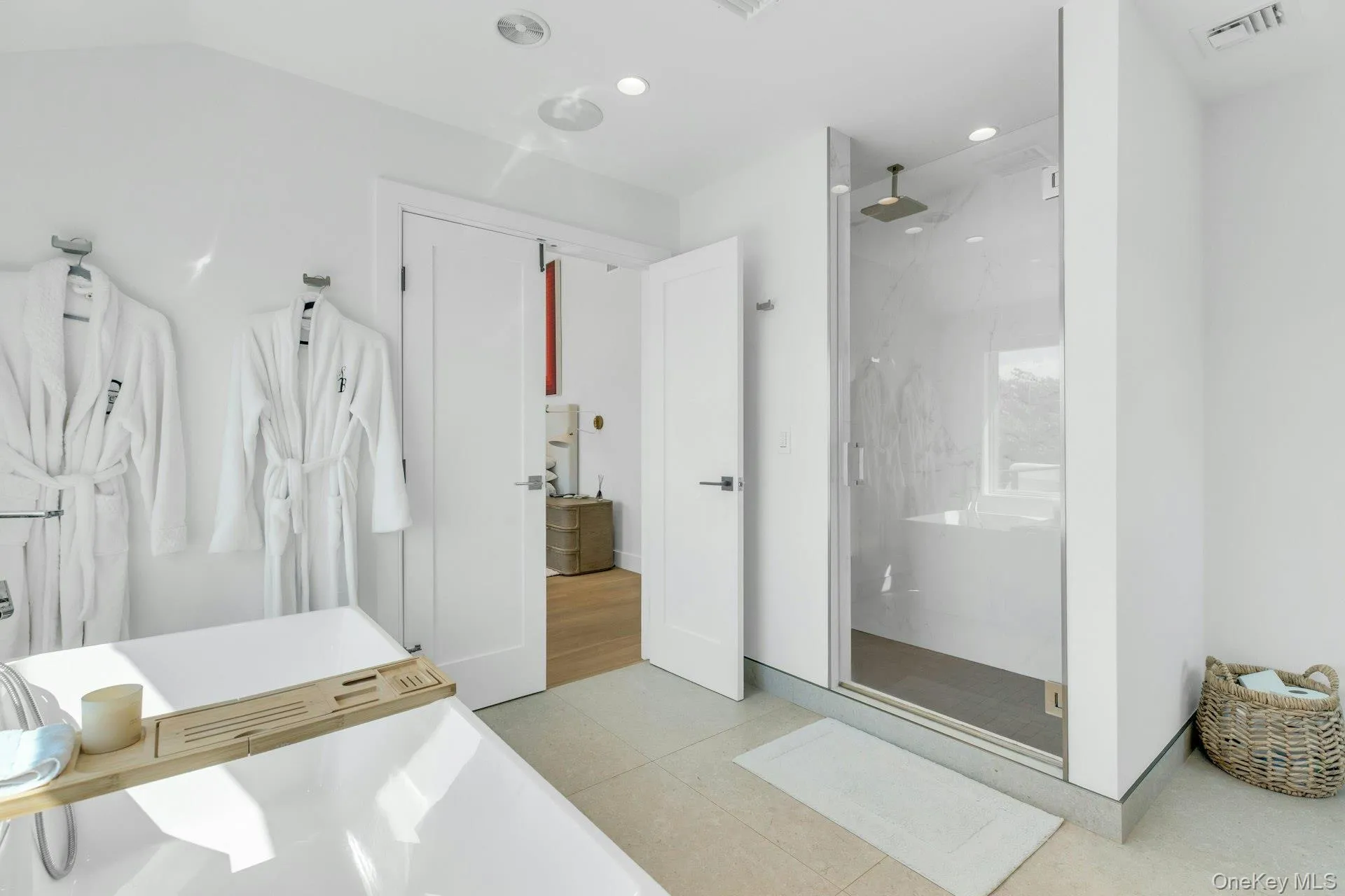 Contemporary bathroom featuring a freestanding soaking tub and a spacious glass-enclosed shower with a rainfall showerhead Contemporary bathroom featuring a freestanding soaking tub and a spacious glass-enclosed shower with a rainfall showerhead