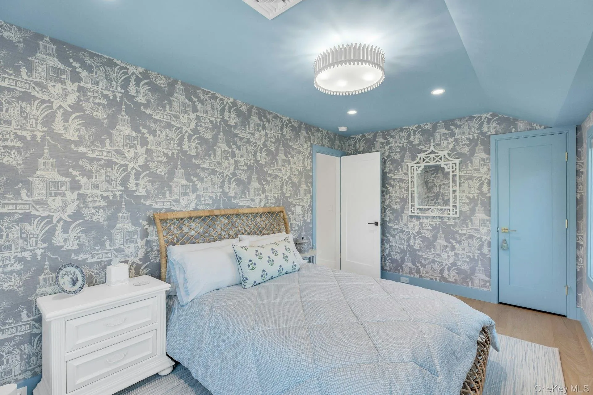 Hardwood-style flooring with a blue-painted ceiling, recessed lighting, and a contemporary ceiling fixture Hardwood-style flooring with a blue-painted ceiling, recessed lighting, and a contemporary ceiling fixture